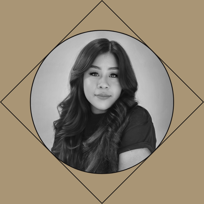 Black and white portrait of a young woman with long, wavy hair, posing against a plain wall, with geometric design elements in the background.