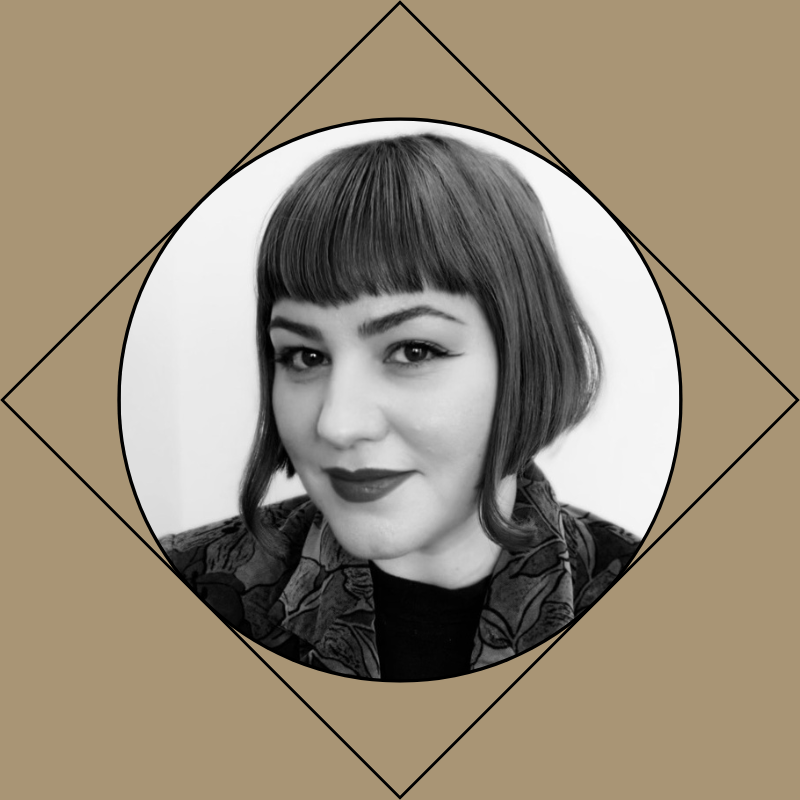 Black and white portrait of a female hairstylist with a dark bob haircut and bangs, smiling softly, wearing a patterned top or jacket.