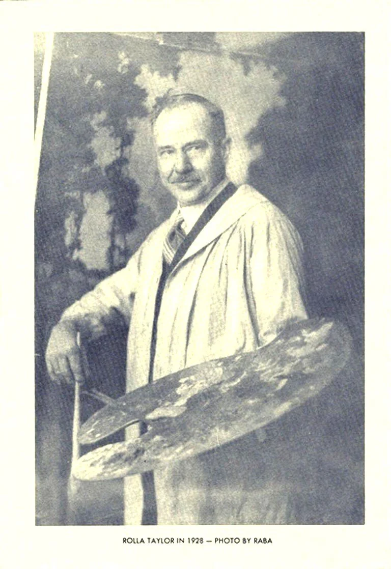 A black and white portrait of Rolla Taylor from 1928, wearing a painter's smock and holding a large paint palette and brush, with a background of trees and sky.