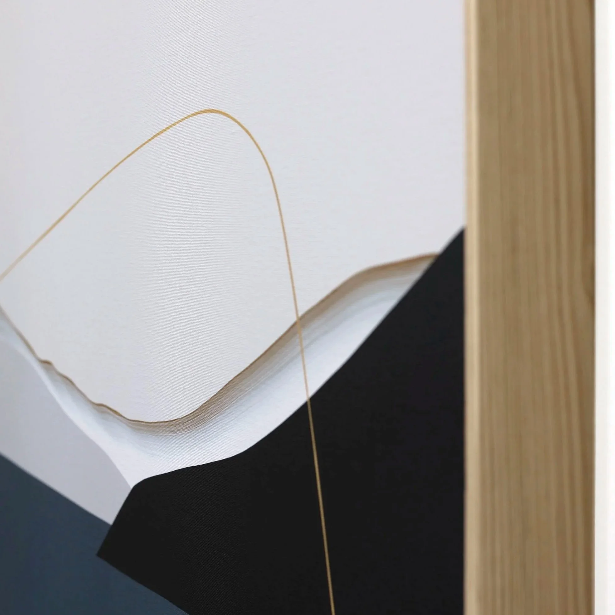 Close-up of an Amy Stewart abstract prints,  with a minimalist design featuring curved shapes and a thin gold line on a white background.