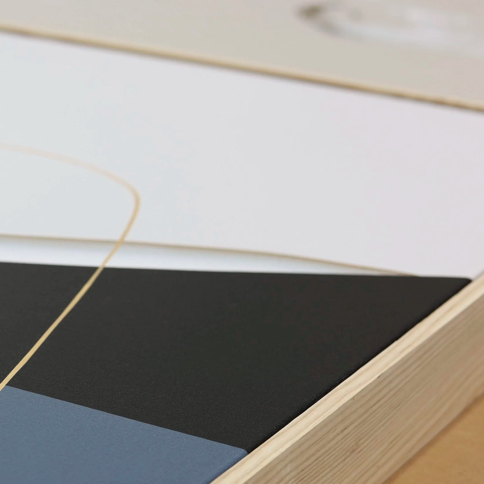 Amy Stewart abstract prints,  Close-up of colorful abstract on canvas and a wooden frame.