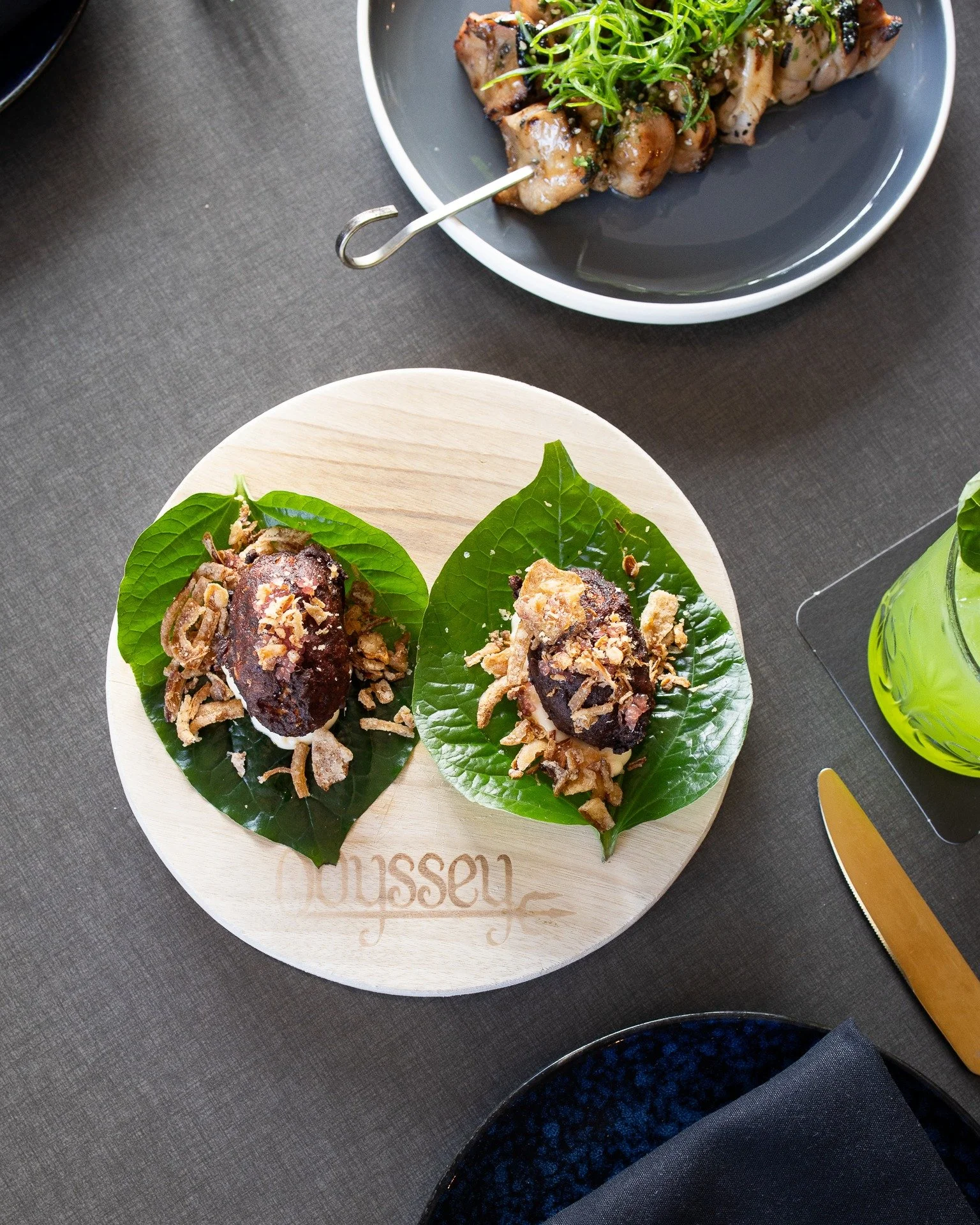 Balinese spiced fish cake, with creamy kewpie, bursts of finger lime and crispy fried shallots, all nestled in a fragrant betel leaf &mdash; fresh, peppery and slightly aromatic.

Pick it up, fold it like a taco, and enjoy.

Can't think of a better w