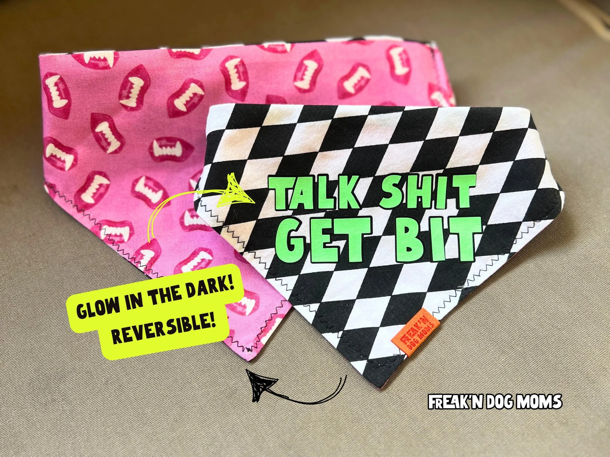 Reversible Halloween dog bandana featuring black and white checkerboard "Talk Shit Get Bit" design and pink glow-in-the-dark vampire print, fun dog costume accessory