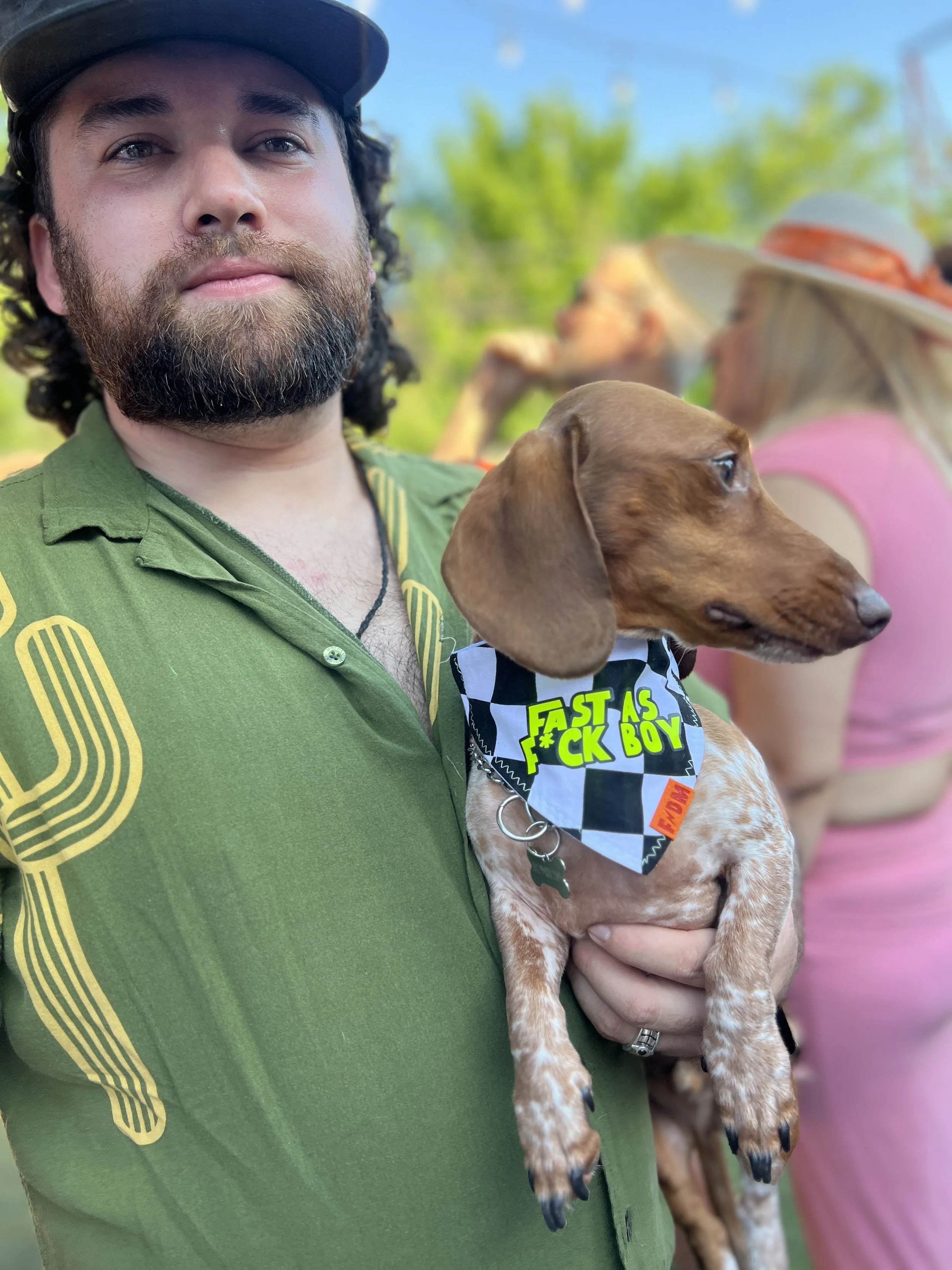Funny dog bandana with checkered racing flag print and neon "Fast As F*ck Boy" text. Handmade over-the-collar pet bandana for race day, zoomies, dog birthdays, pet photos, and unique dog gifts.
