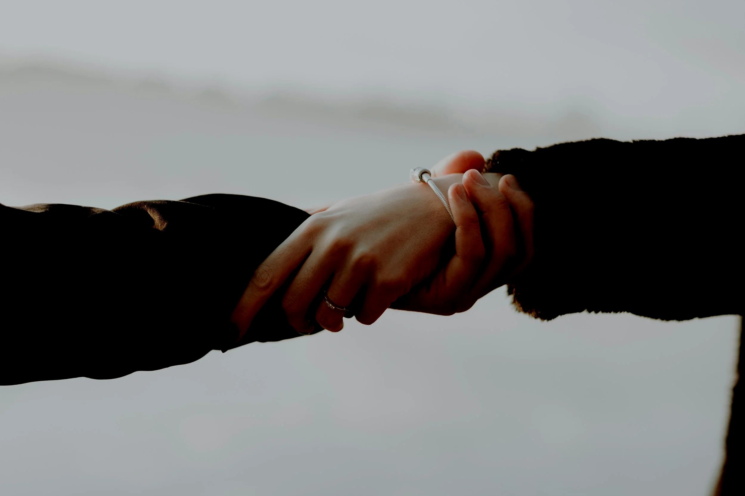 Physical therapist and patient holding hands, symbolizing partnership in healing and wellness