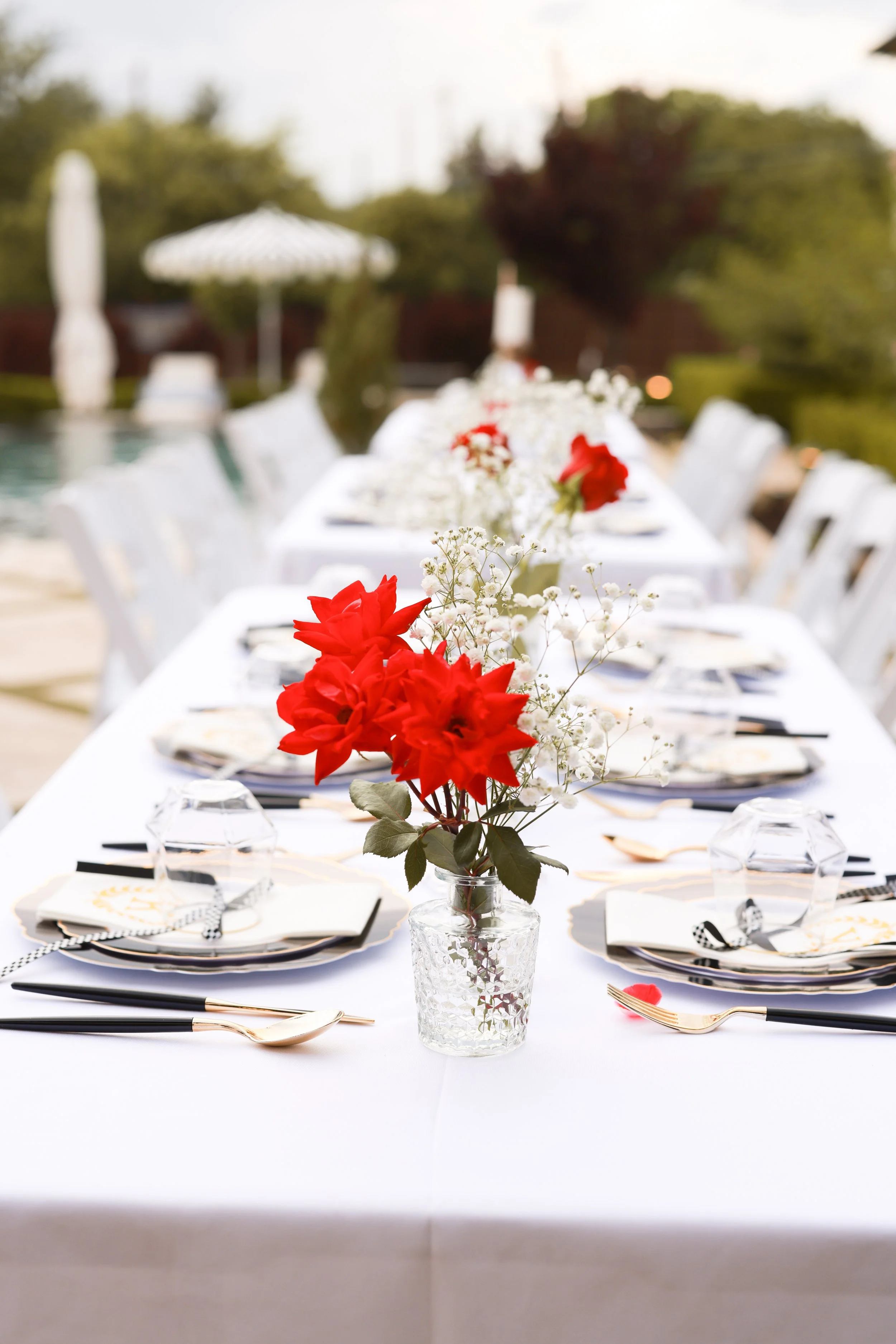 Event table decorated with red and white flowers