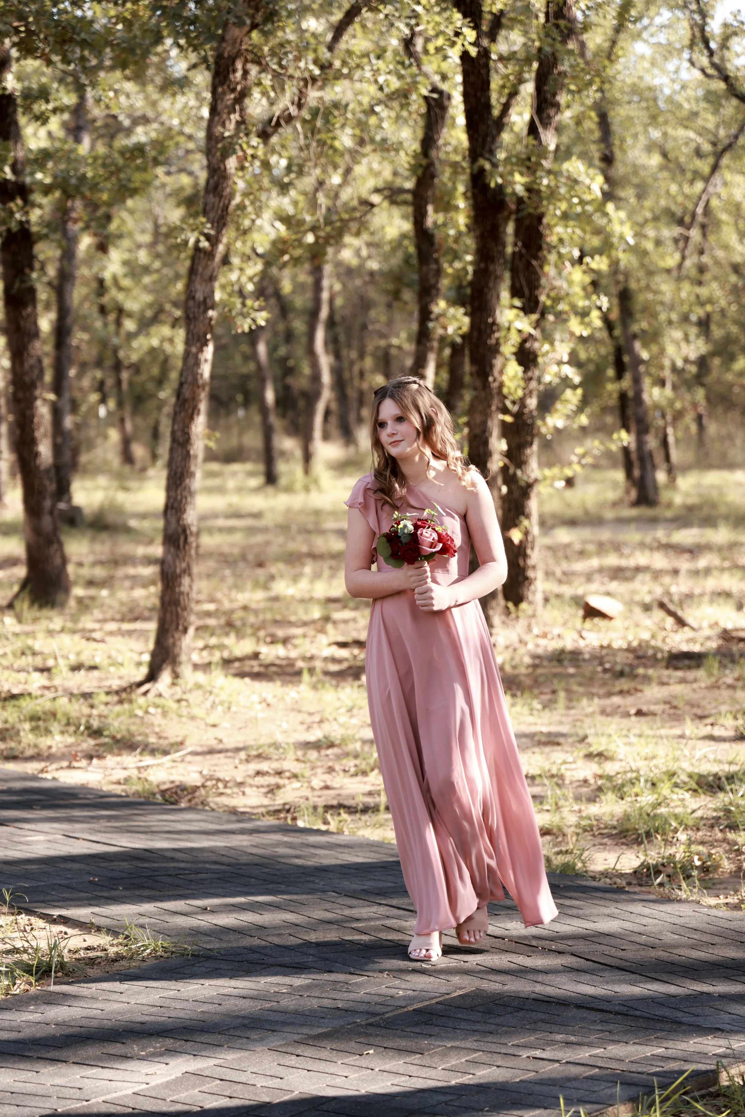 bridesmaid on a dusty rose dress making her entrance at dfw wedding
