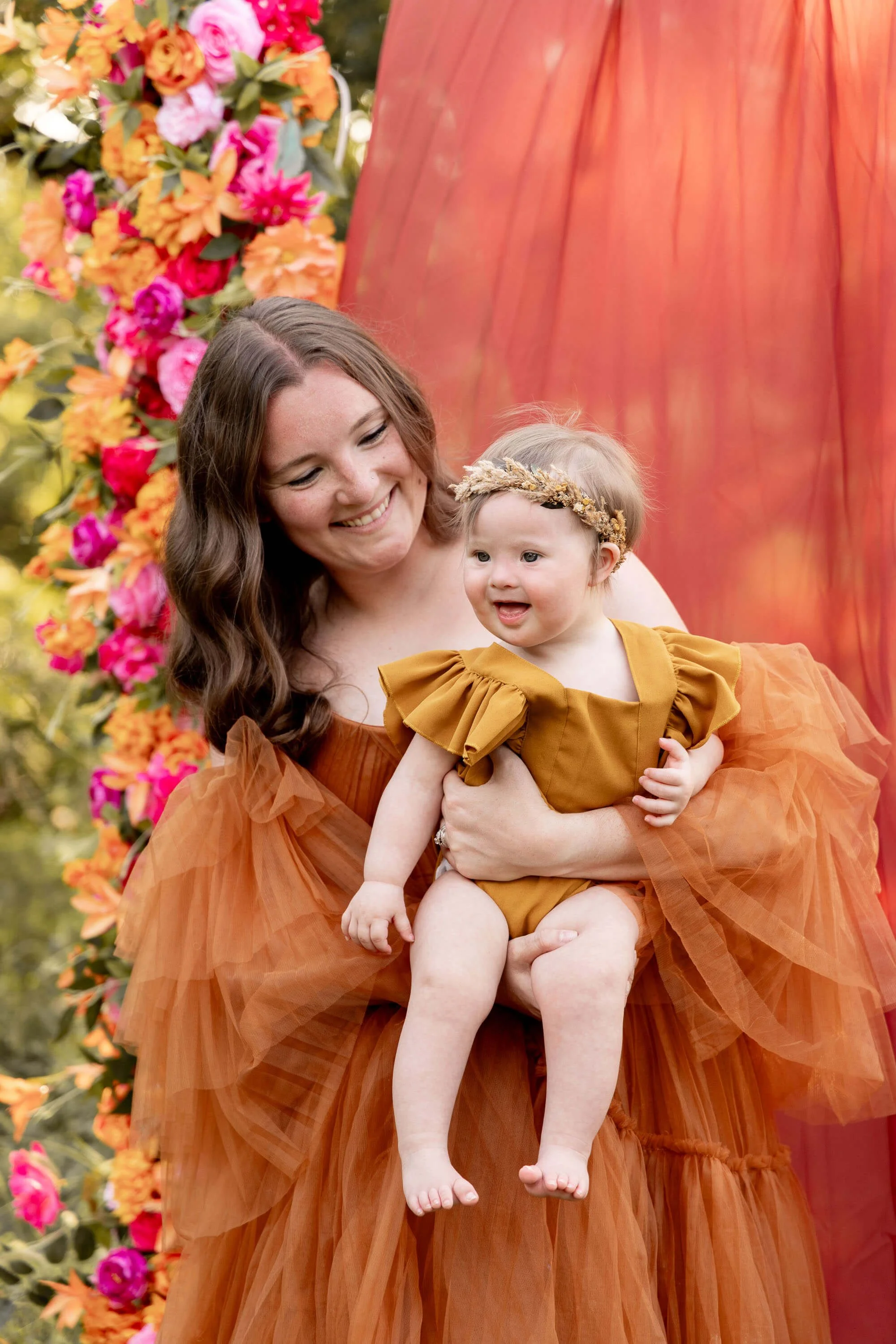 mom holding toddler girl smiling in Grapevine Texas