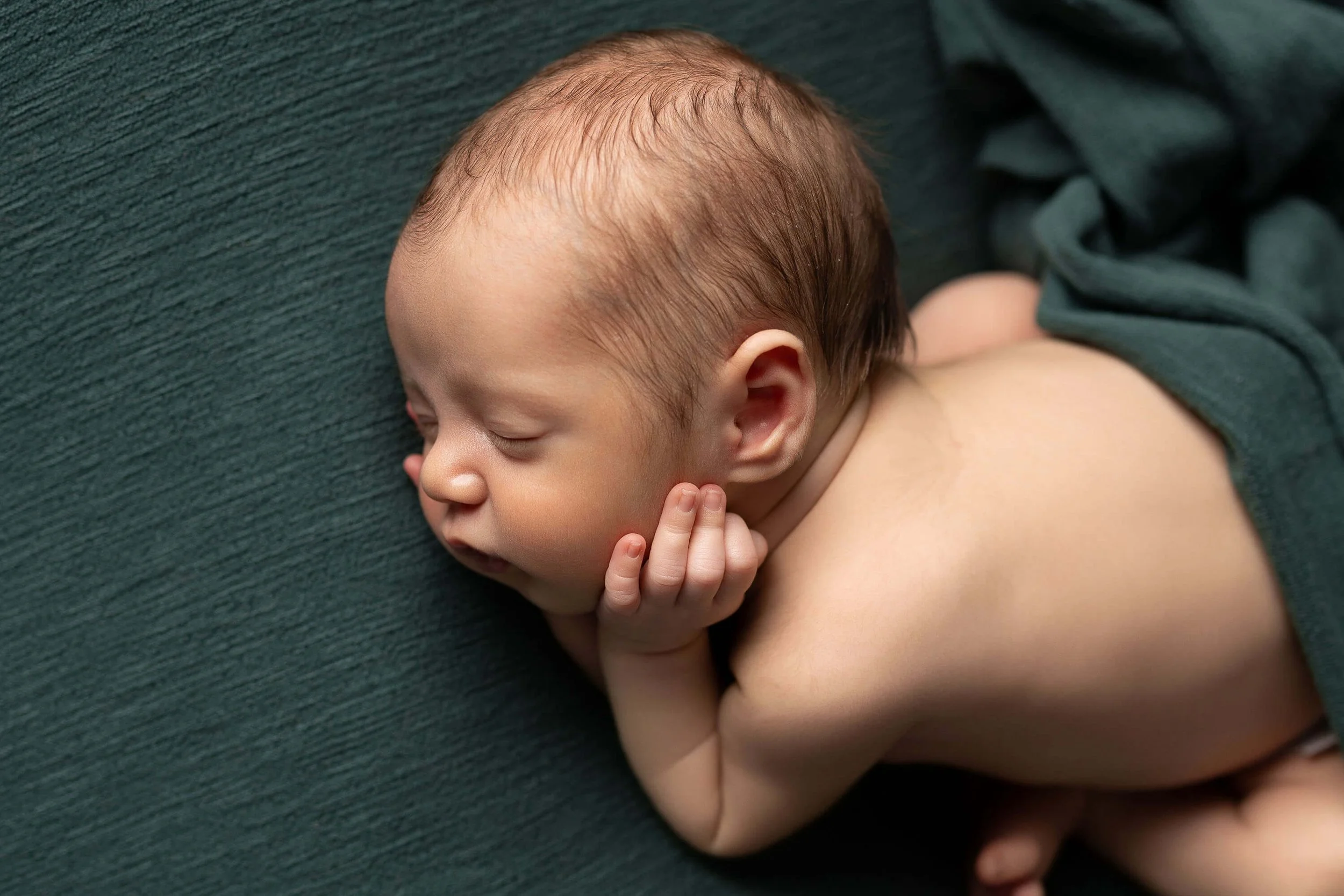 newborn baby on teal fabric in Fort Worth Texas