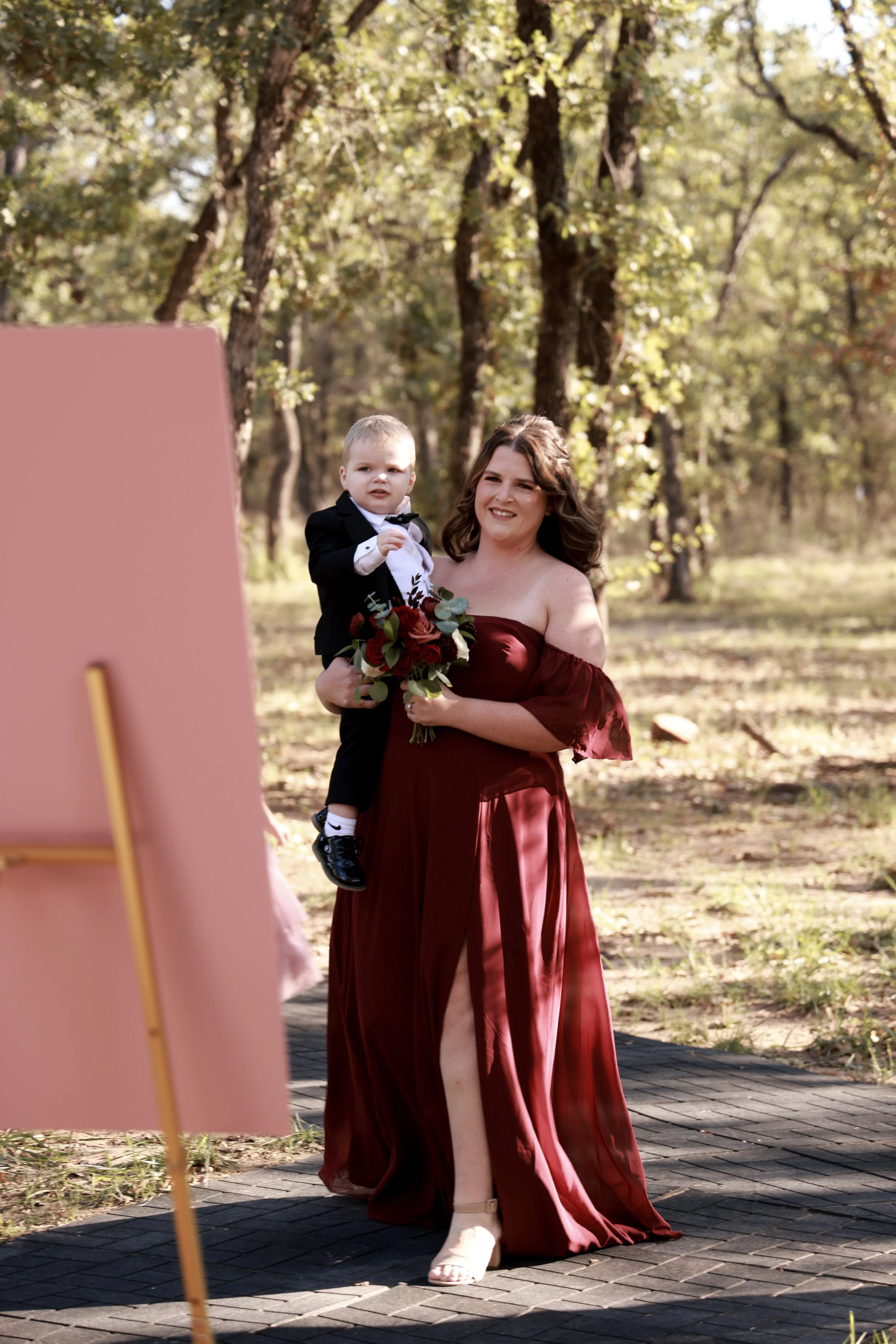 bridesmaid holding brides baby at Dallas wedding