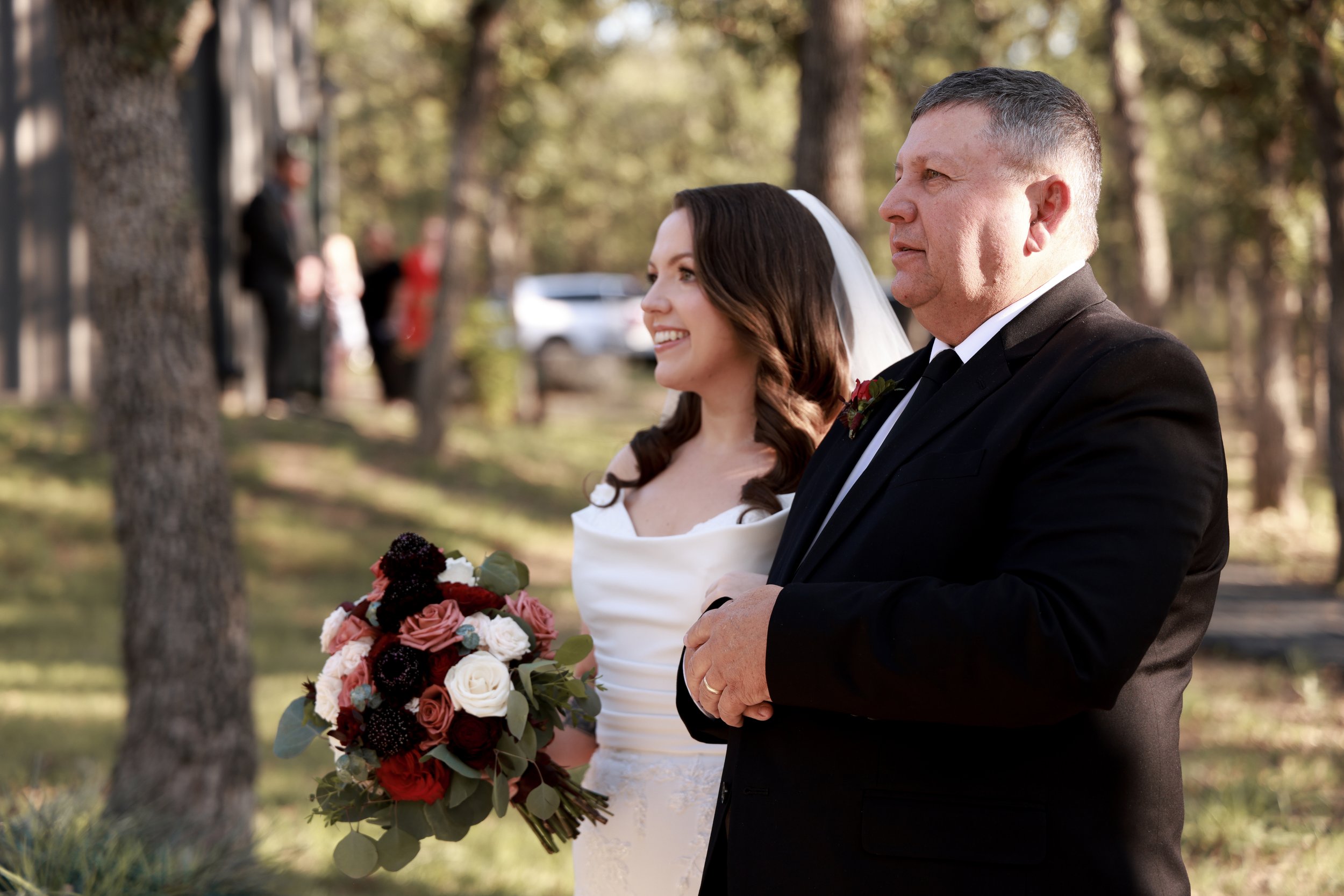 close up of bride and her dad walking down the isle 