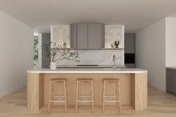Modern kitchen with a marble backsplash, gray upper cabinets, and three wooden stools at a light wood island.