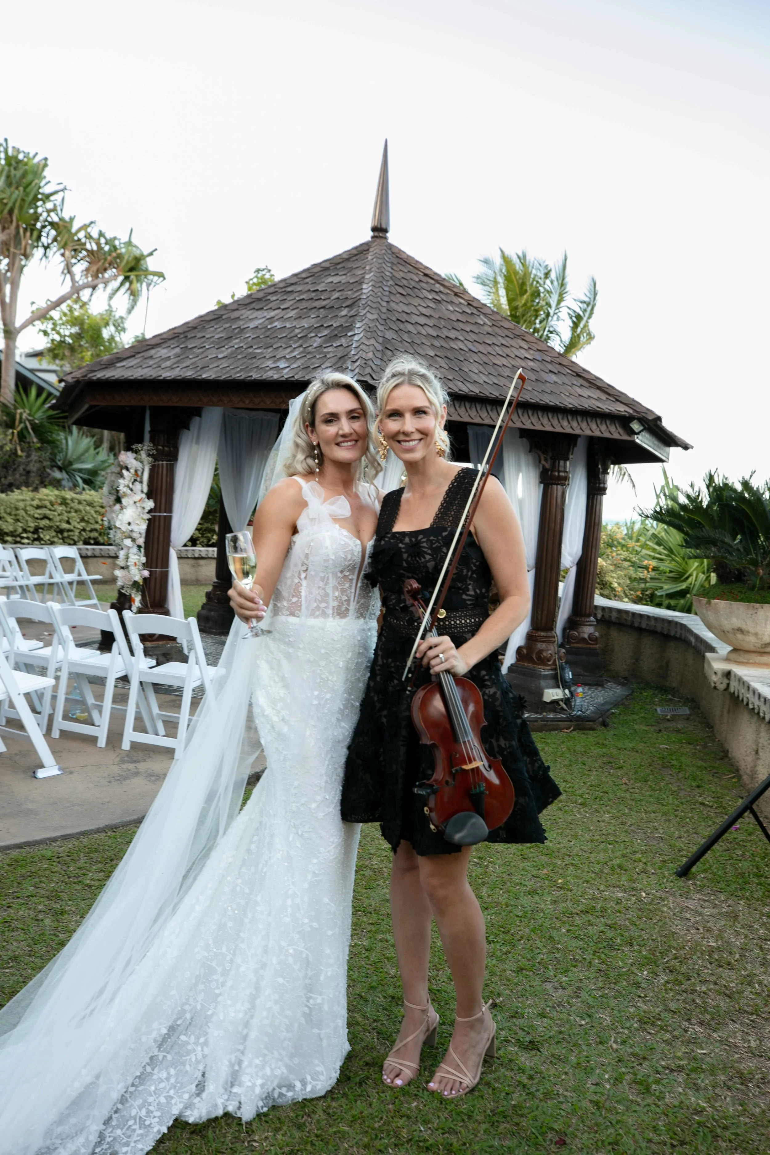 Wedding ceremony on the lawn at Villa Botanica, Airlie Beach, with stunning Whitsundays hinterland views.
