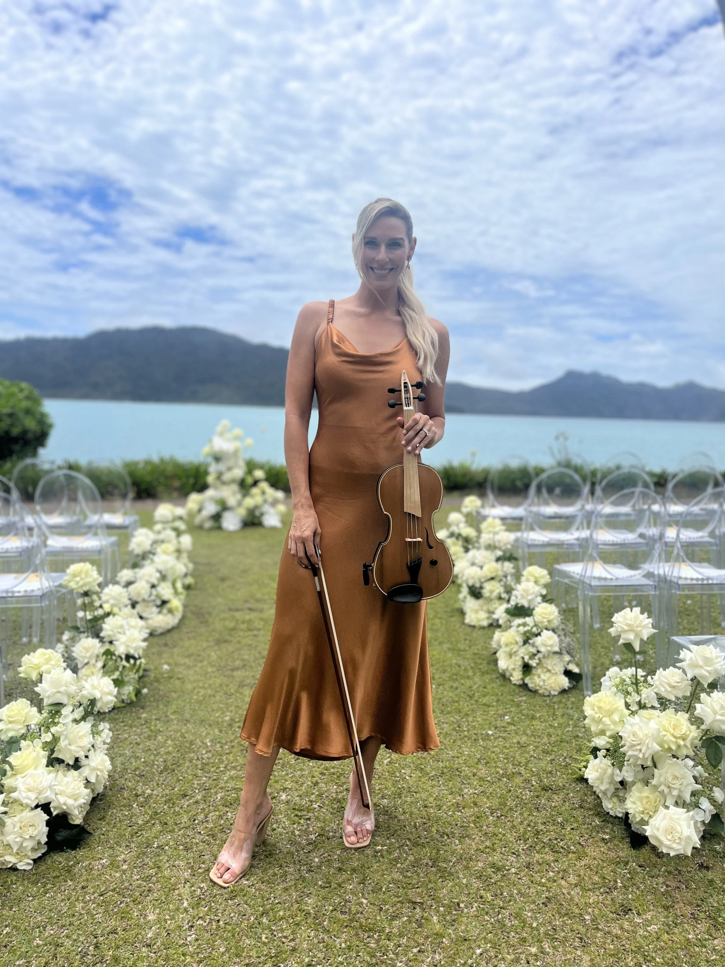 Violinist playing at luxury outdoor wedding venue Hayman Great Barrier Reef