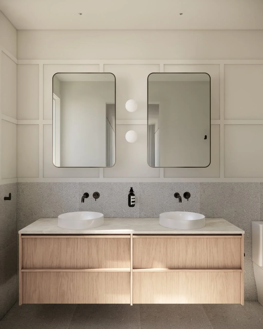 Mount Eliza house, a new split-level four-bedroom family home with Hoad Building Co.
The bathroom and ensuite feature off-the-shelf vanities and overhead cabinets with custom bench tops. Timber wall detailing mirrors that of the home&rsquo;s exterior