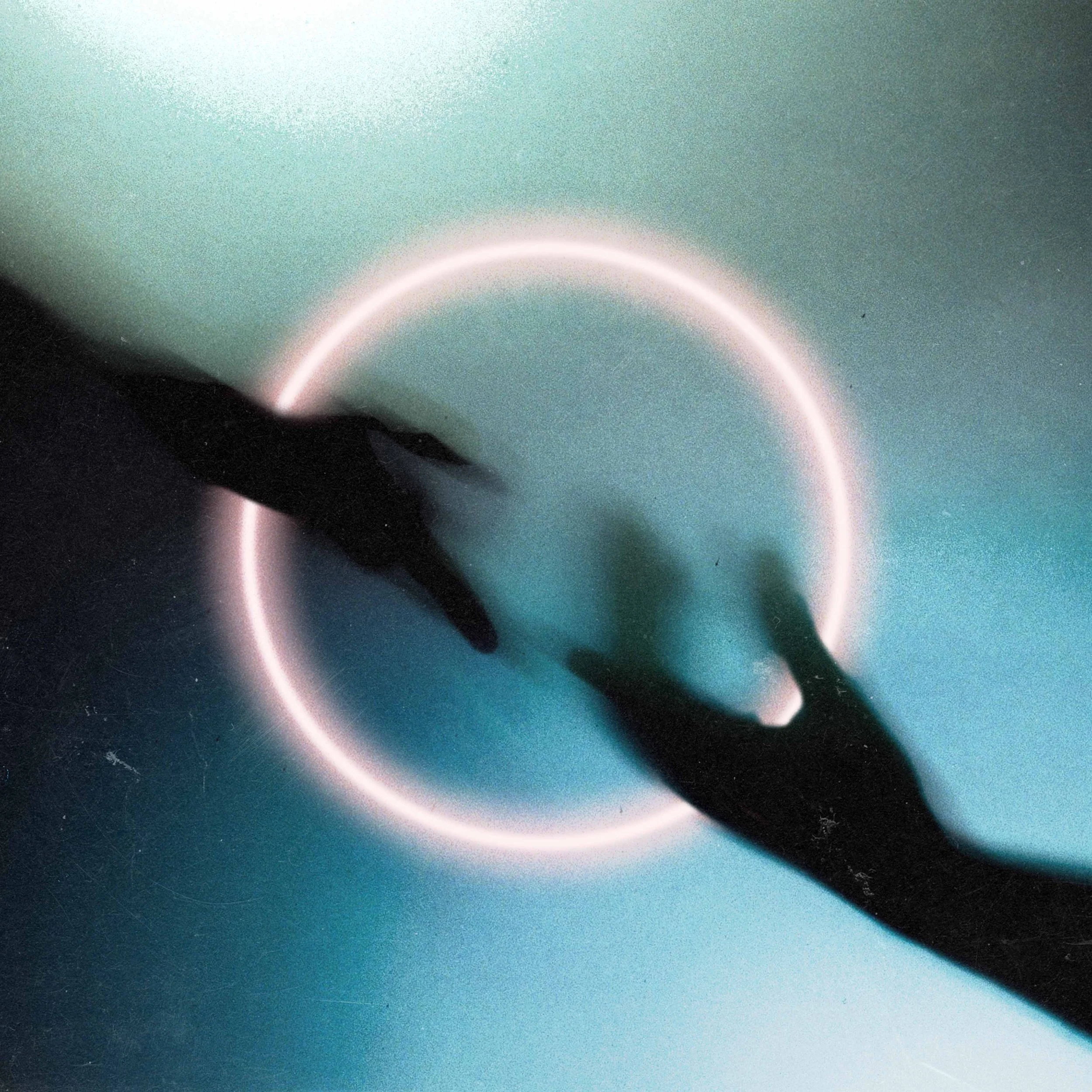 Silhouettes of two hands reaching towards each other over a glowing circular light on a teal background.