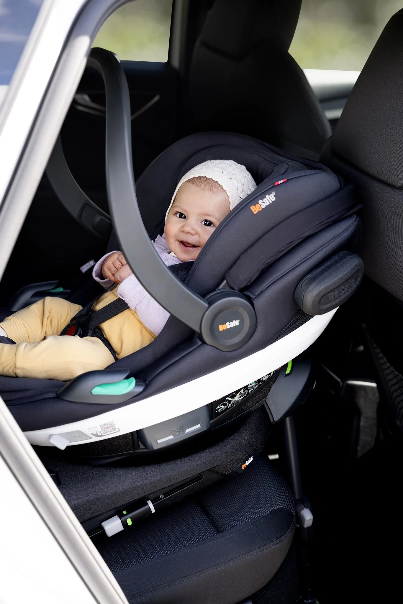 Infant travelling safely in a rear facing car seat, highlighting the importance of choosing the right car seat for family journeys