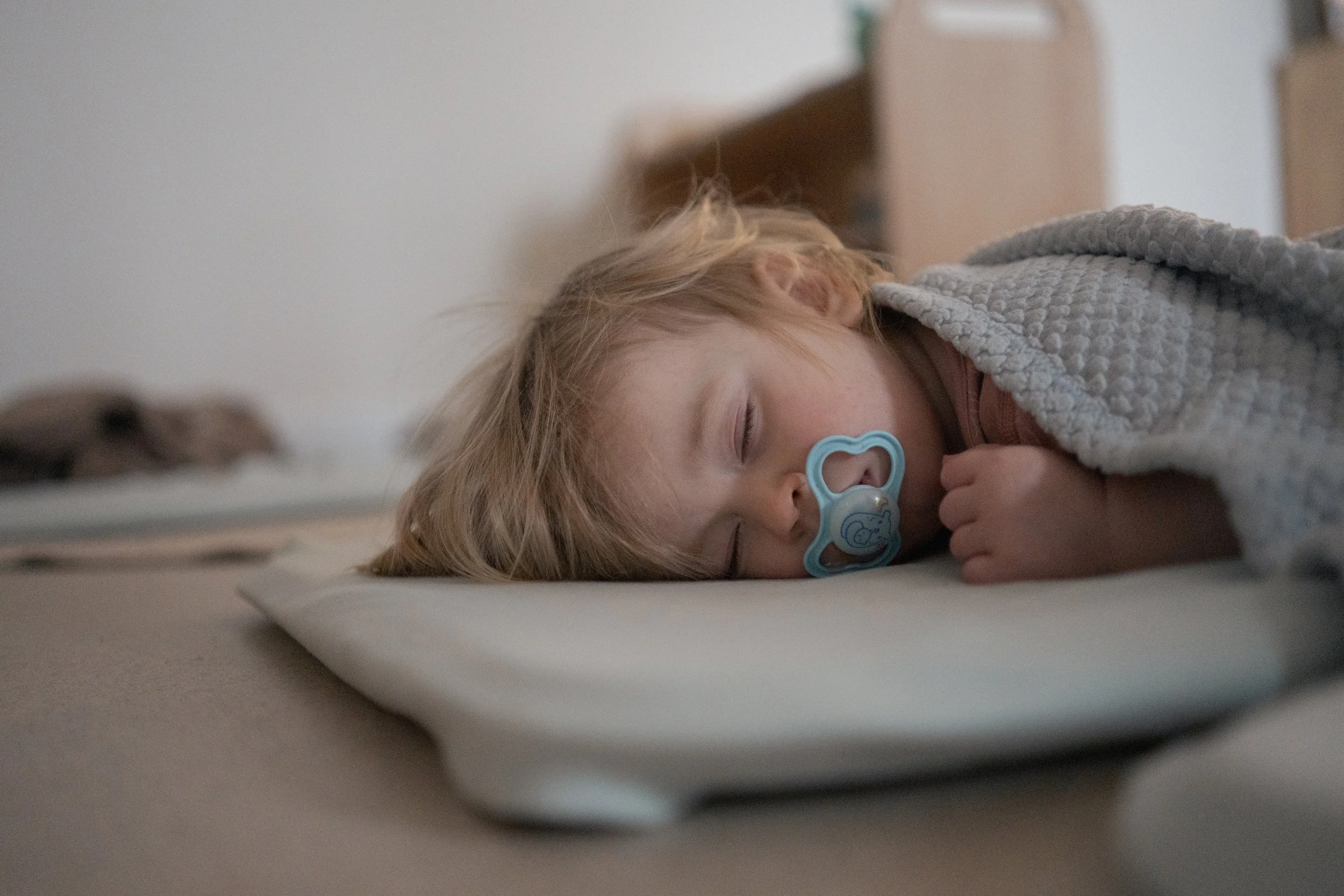 Peaceful child sleeping soundly, tucked under a cosy blanket