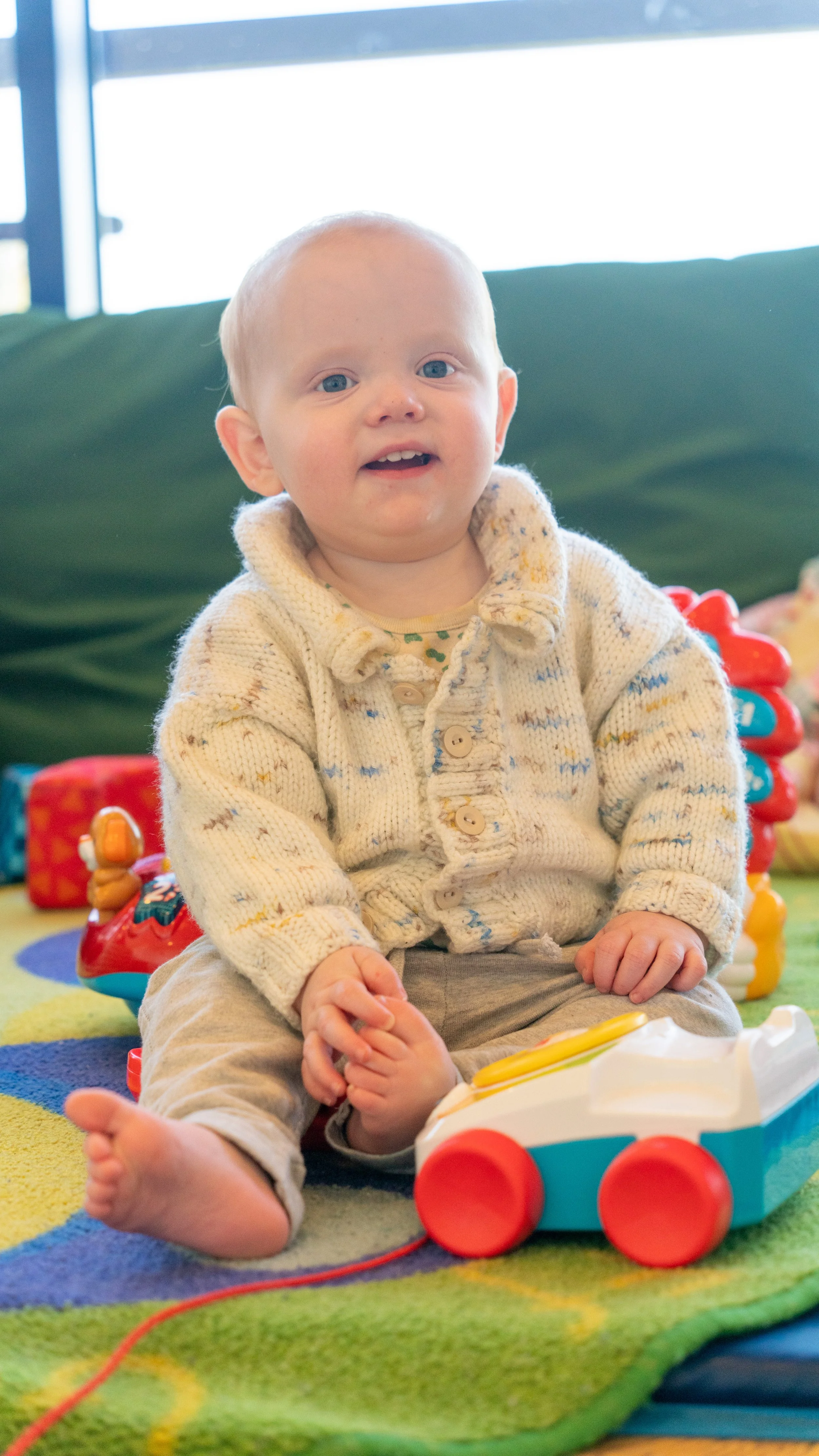 Child playing with soft toys in a well-equipped crèche