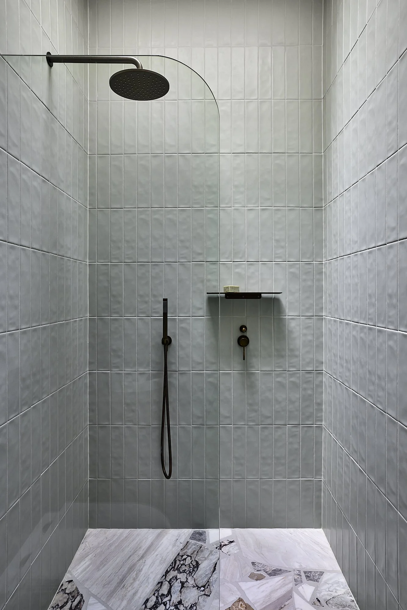 Textured tiled shower in a restored heritage terrace by Balmain architect Passer Architects.
