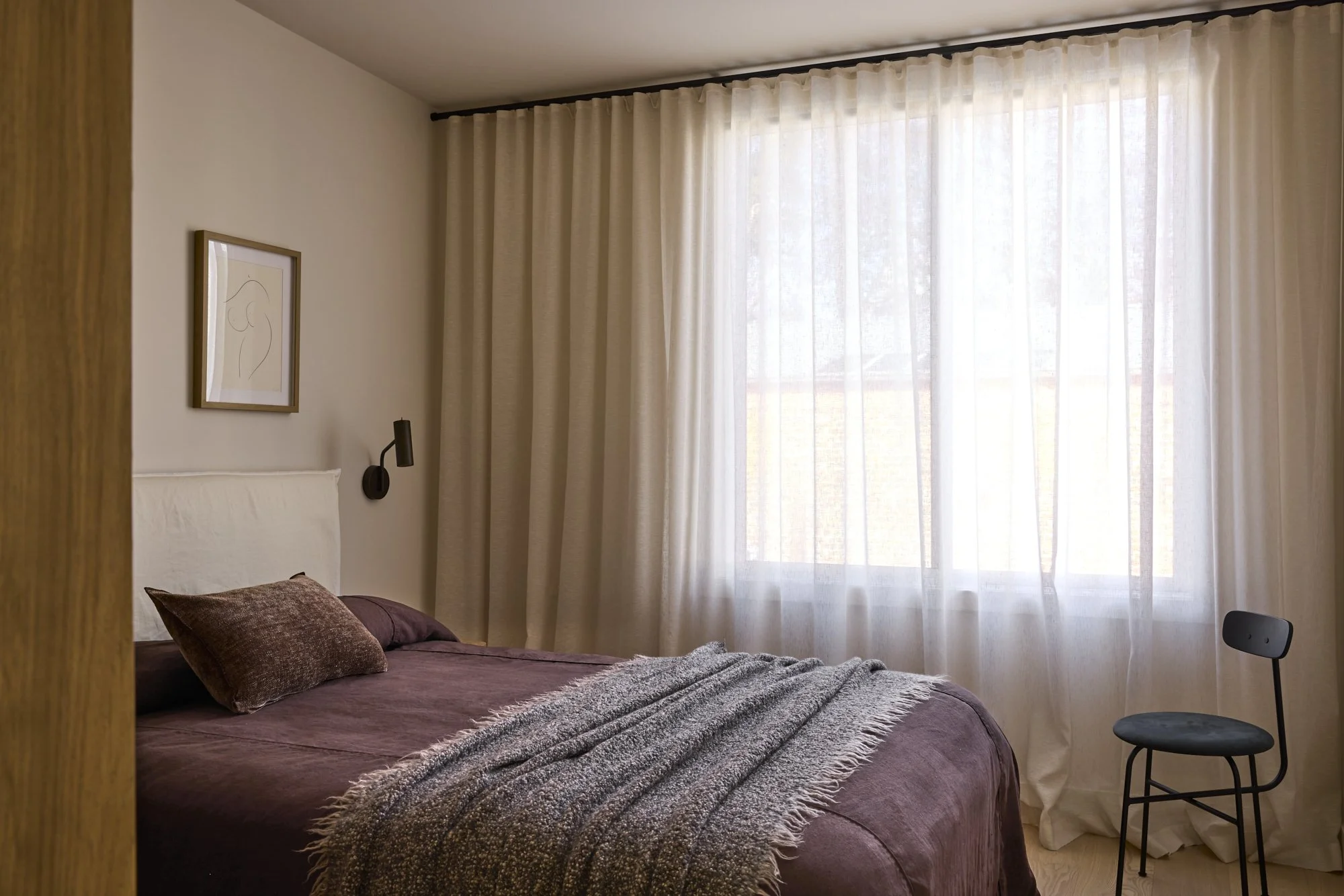 Soft neutral bedroom with full height curtains in a premium Sydney terrace renovation.