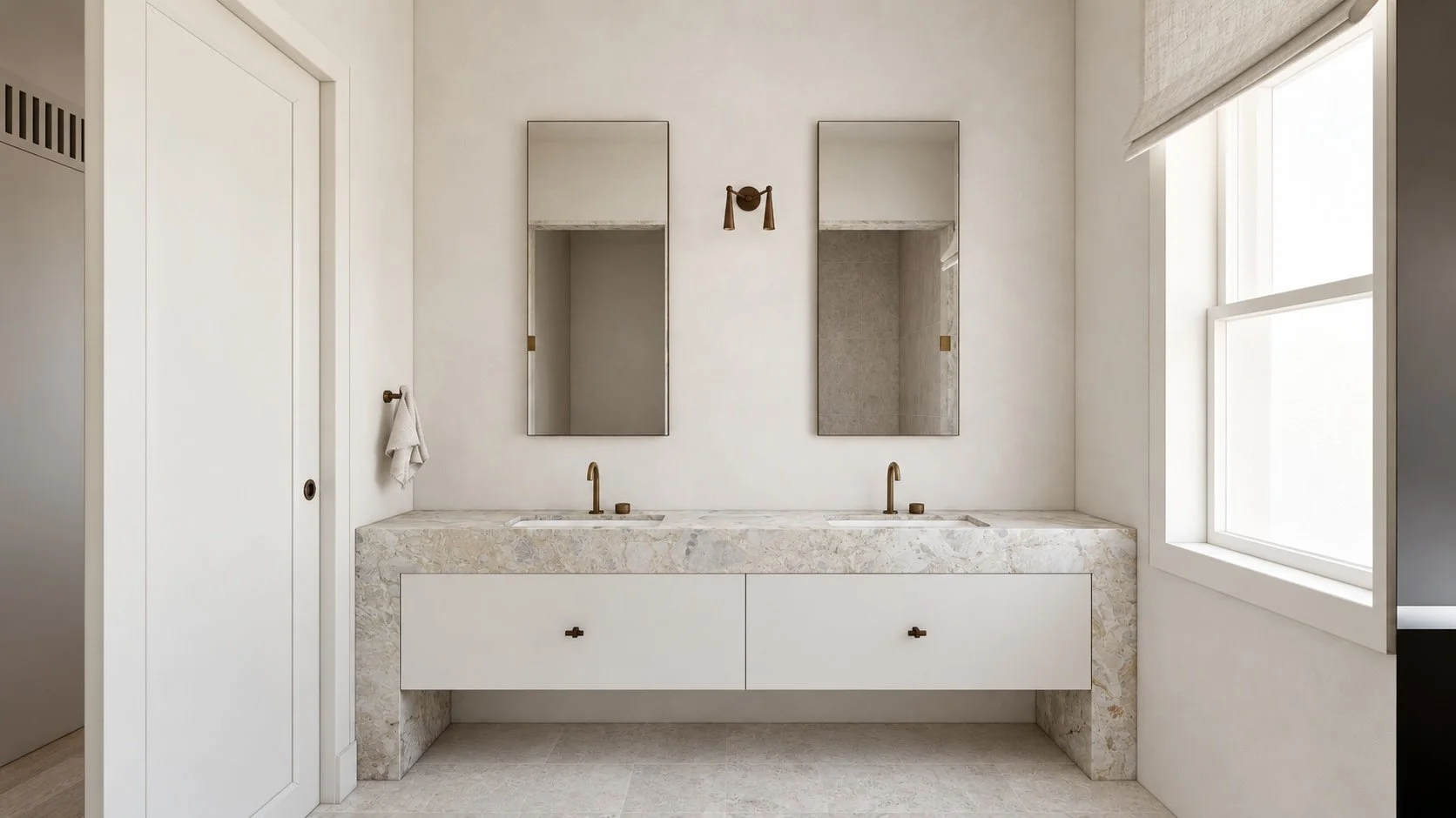 Primary ensuite at P&O House with twin basins, a stone vanity, tall mirrors and bronze detailing.
