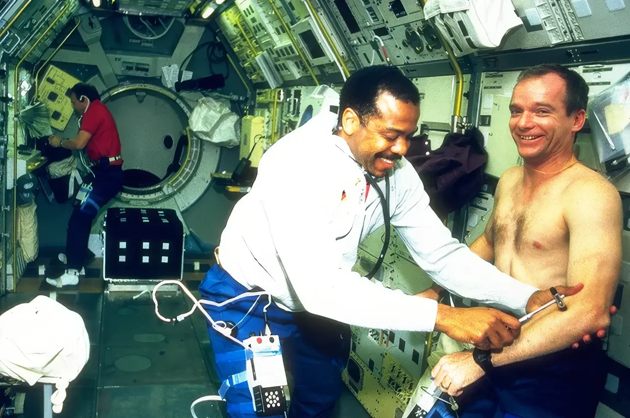 Dr. Bernard Harris performing medical experiment in space