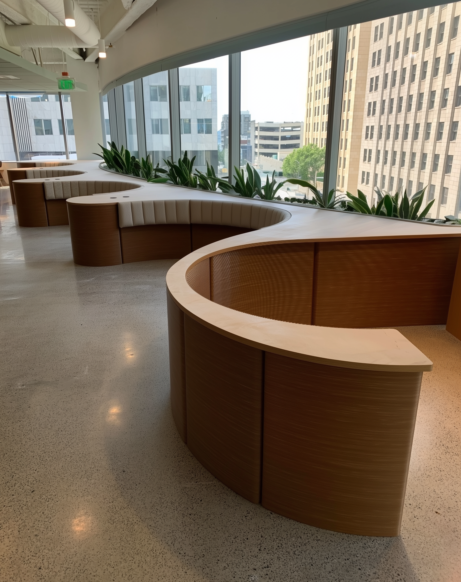 3D printed furniture, 3D printed banquette - Modern office lounge with curved wooden benches, large windows, and green plants in an urban high-rise building.