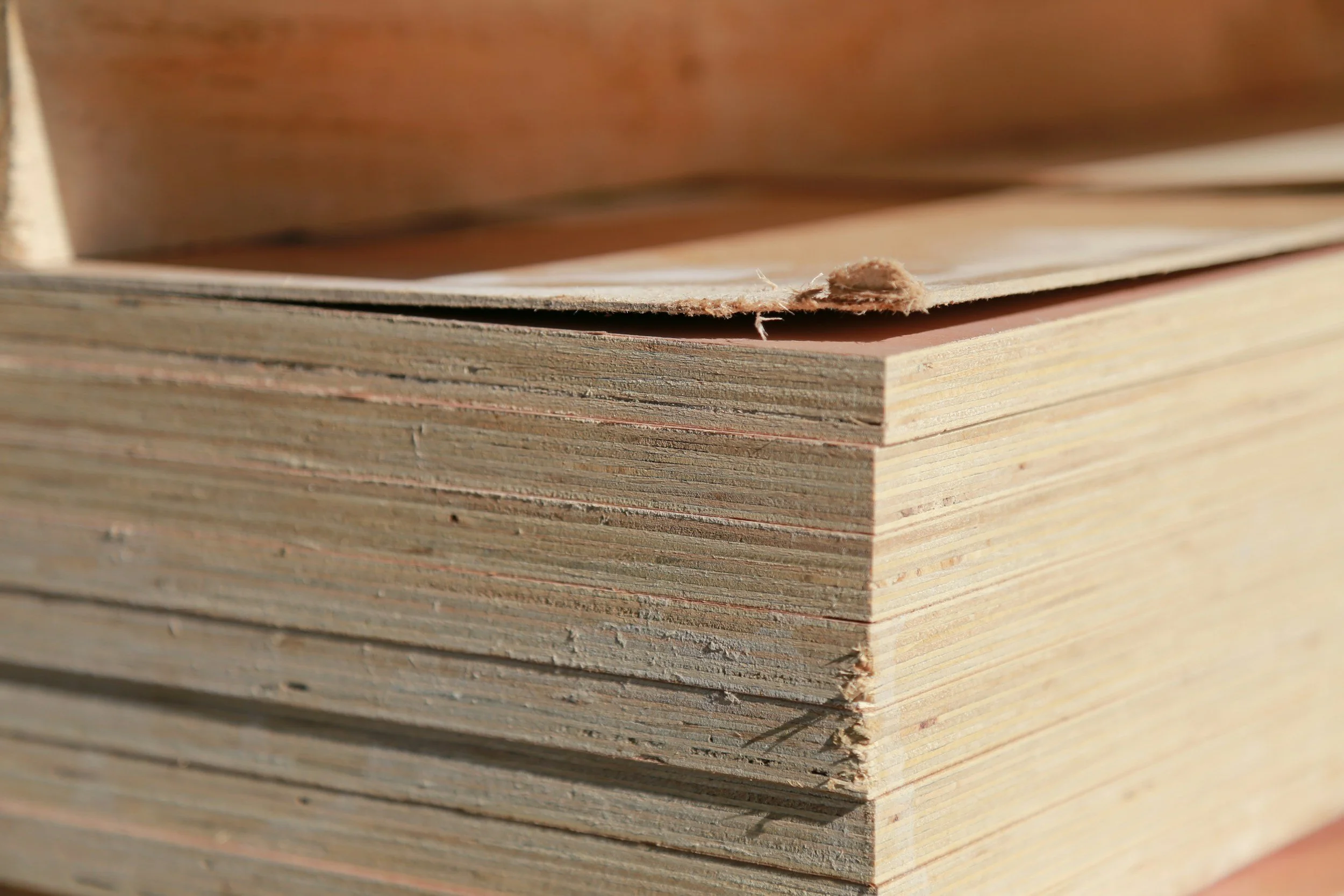 Close-up of a stack of wooden planks with rough edges.
