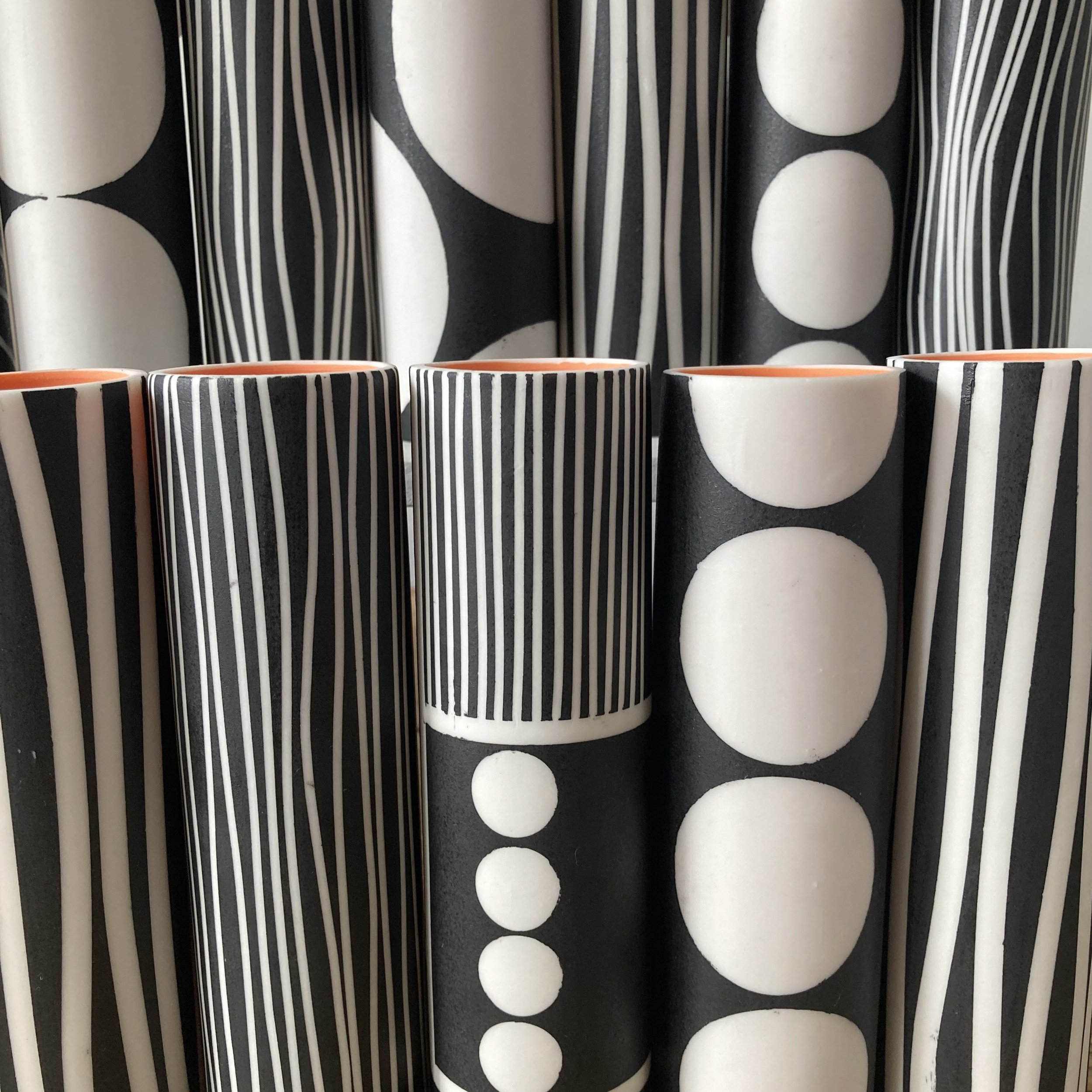 Slipcast porcelain stem vases/tea light holders showing a variety of 60's inspired black and white designs