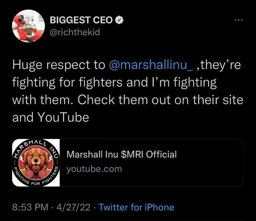Tweet from BIGGEST CEO mentioning @marshallinu_ and promoting the Marshall Inu $MRI YouTube channel, with a profile picture of a person in a red outfit holding a package or box.