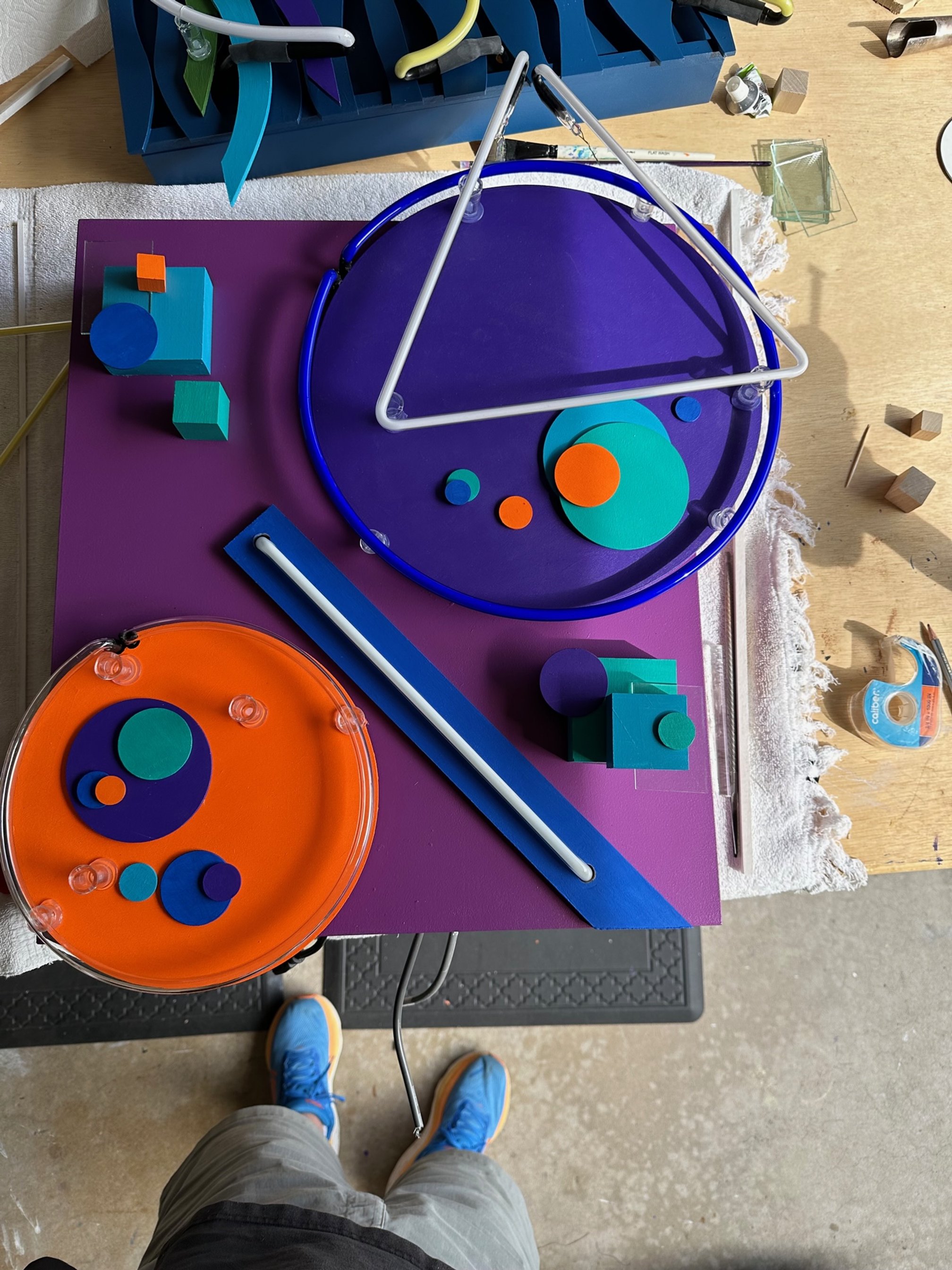 abstract piece roughly laid out and experimenting with paint and placement of additional square and round wood elements