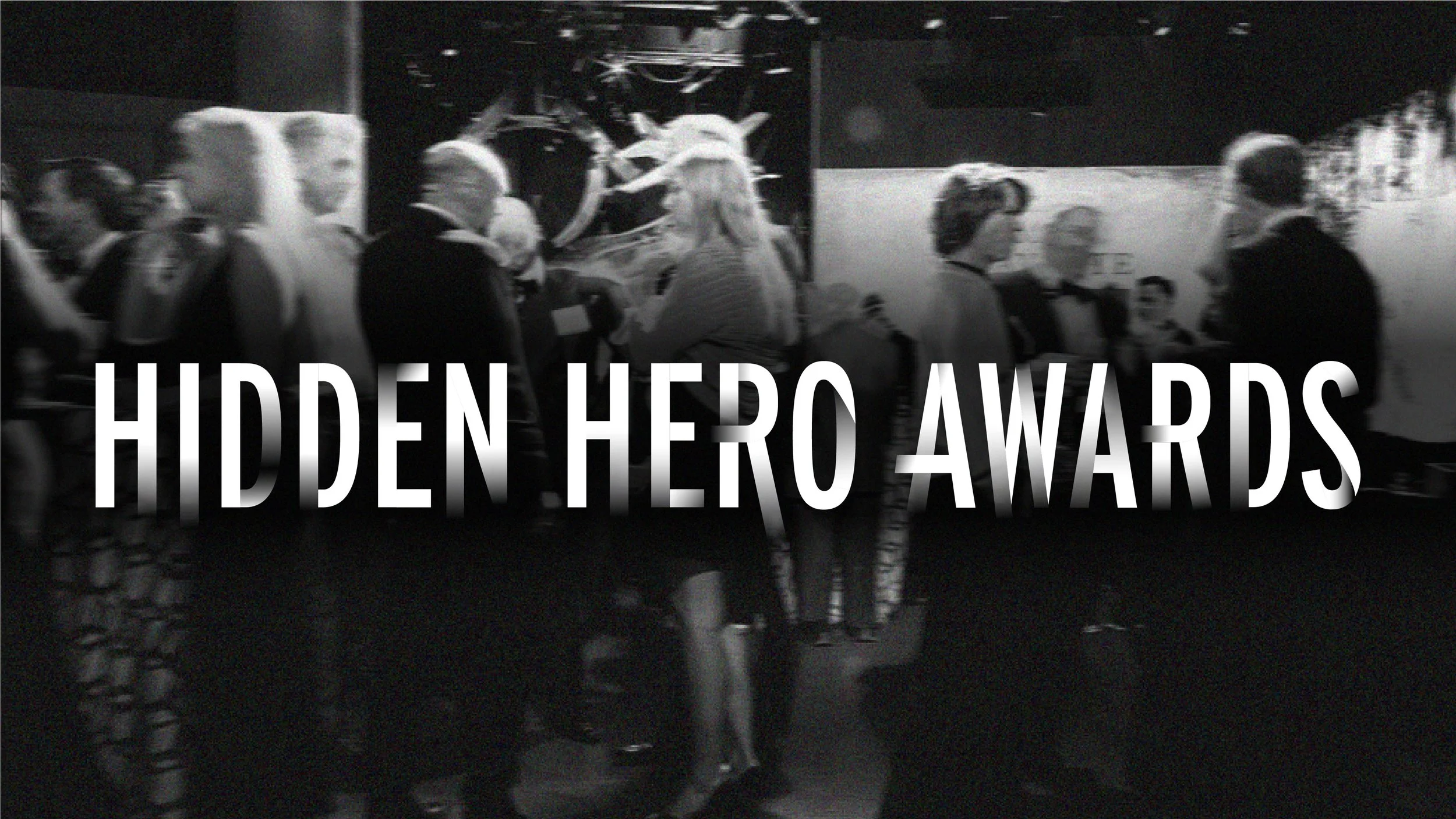 Hidden Hero Awards white logo text overlaid on a black and white image of the event cocktail hour.