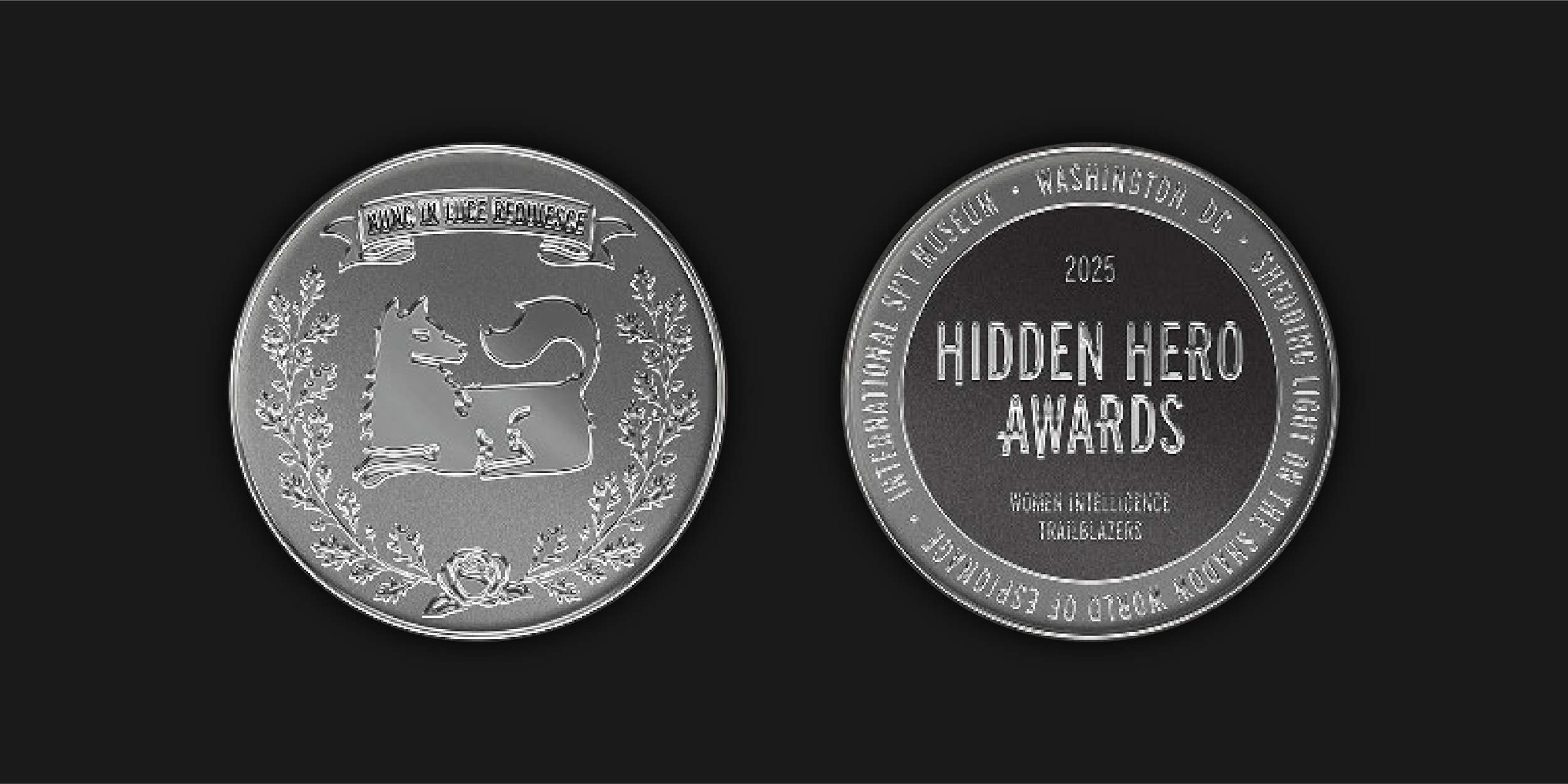 An image of a silver coin front and back featuring an intricate design on one side and the words "Hidden Hero Awards 2025 Women Intelligence Trailblazers" on the other.