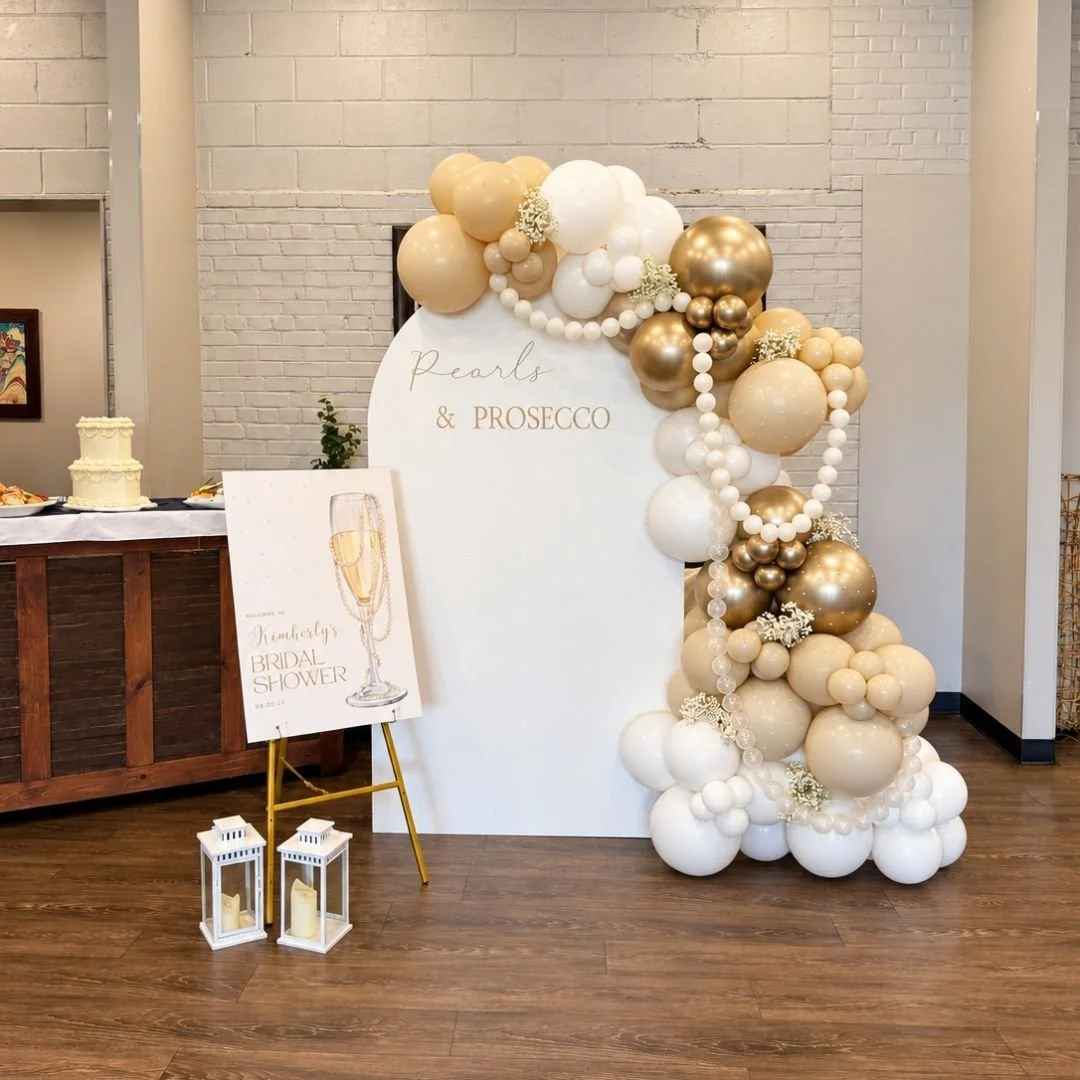 a beautiful pearls and prosecco themed bridal shower backdrop set up in the party room at Campane Trattoria in Fairport, NY