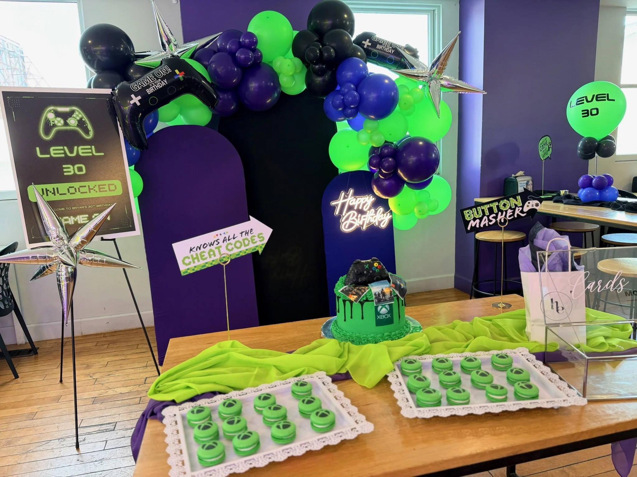 a video-game inspired 30th birthday backdrop and desert table set up at The Playhouse at Swillburger in Rochester NY