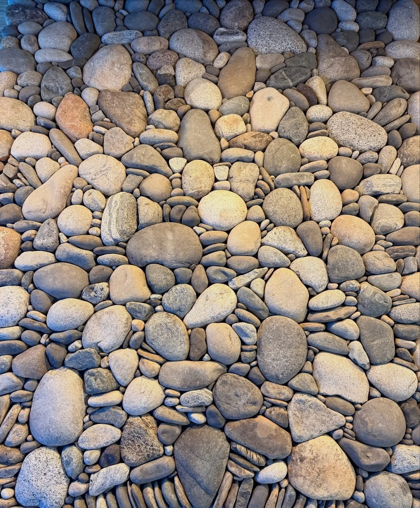 There is an incredible amount of stone above the two arches on this double sided fireplace - roughly 8 by 12 feet #millerstoneworks #stone #stoneart #stonework #stonemasonry #stonemason #naturalstone #drystackstone #design #stonedesign #construction 