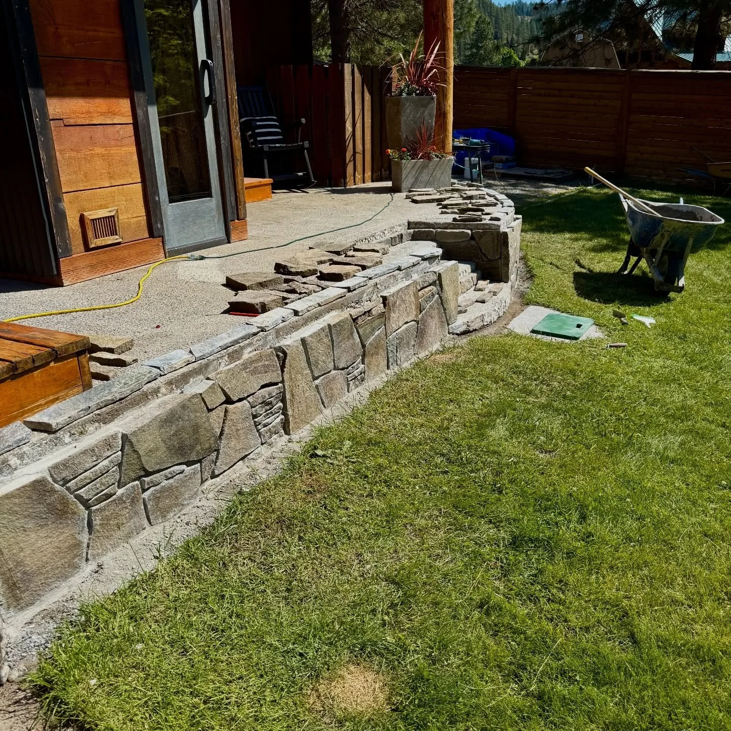 The latest project - new rock and cap on this patio wall with a mix of silver falls stone #millerstoneworks #masonry #stonemasonry #stonework #stonewall