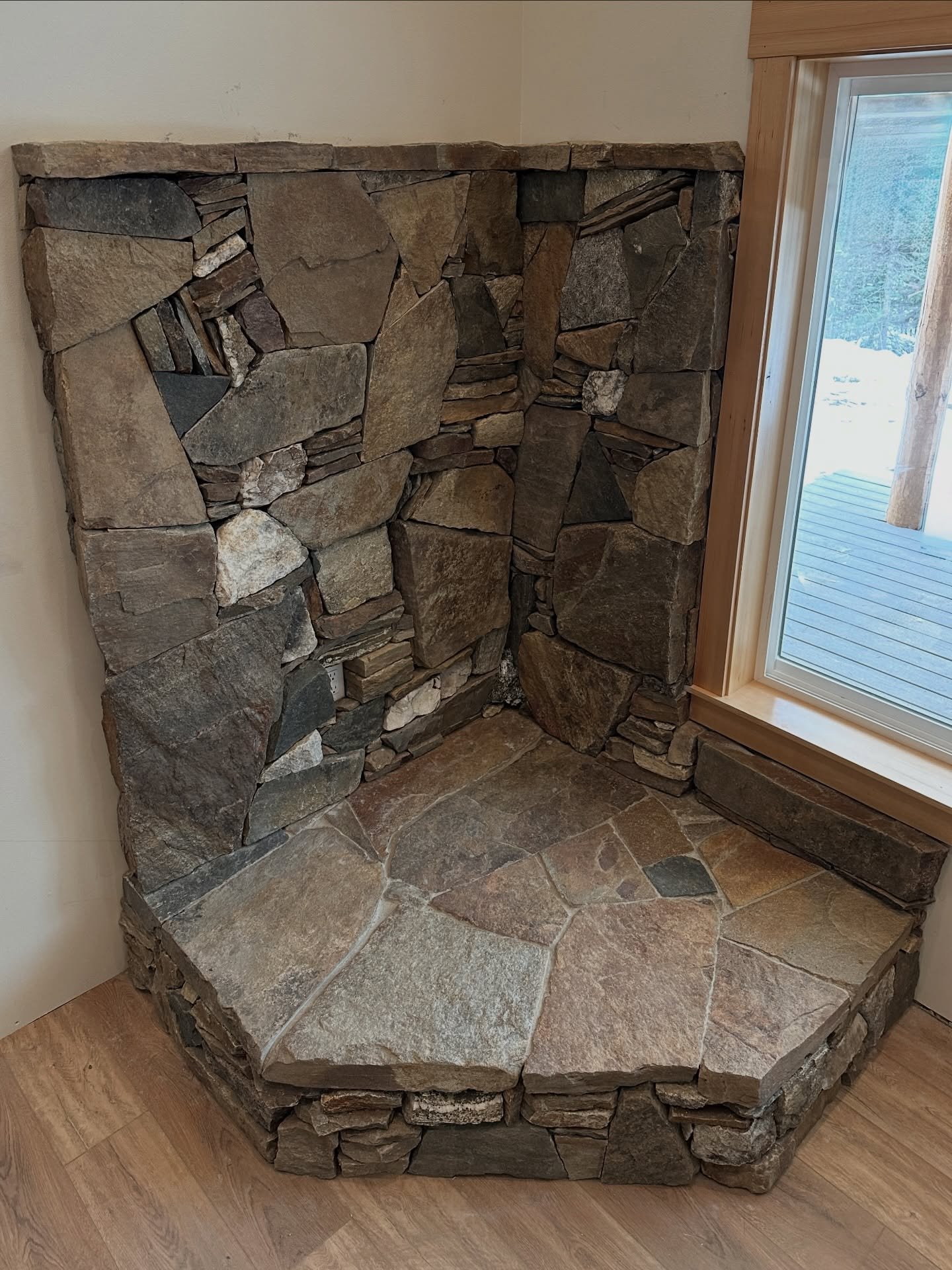A stone home for a wood stove from locally sourced rock, including pieces the home owners were able to collect from their older families property. Everything is better when it has a memory built in #millerstoneworks #woodstove #stonemasonry #locallys