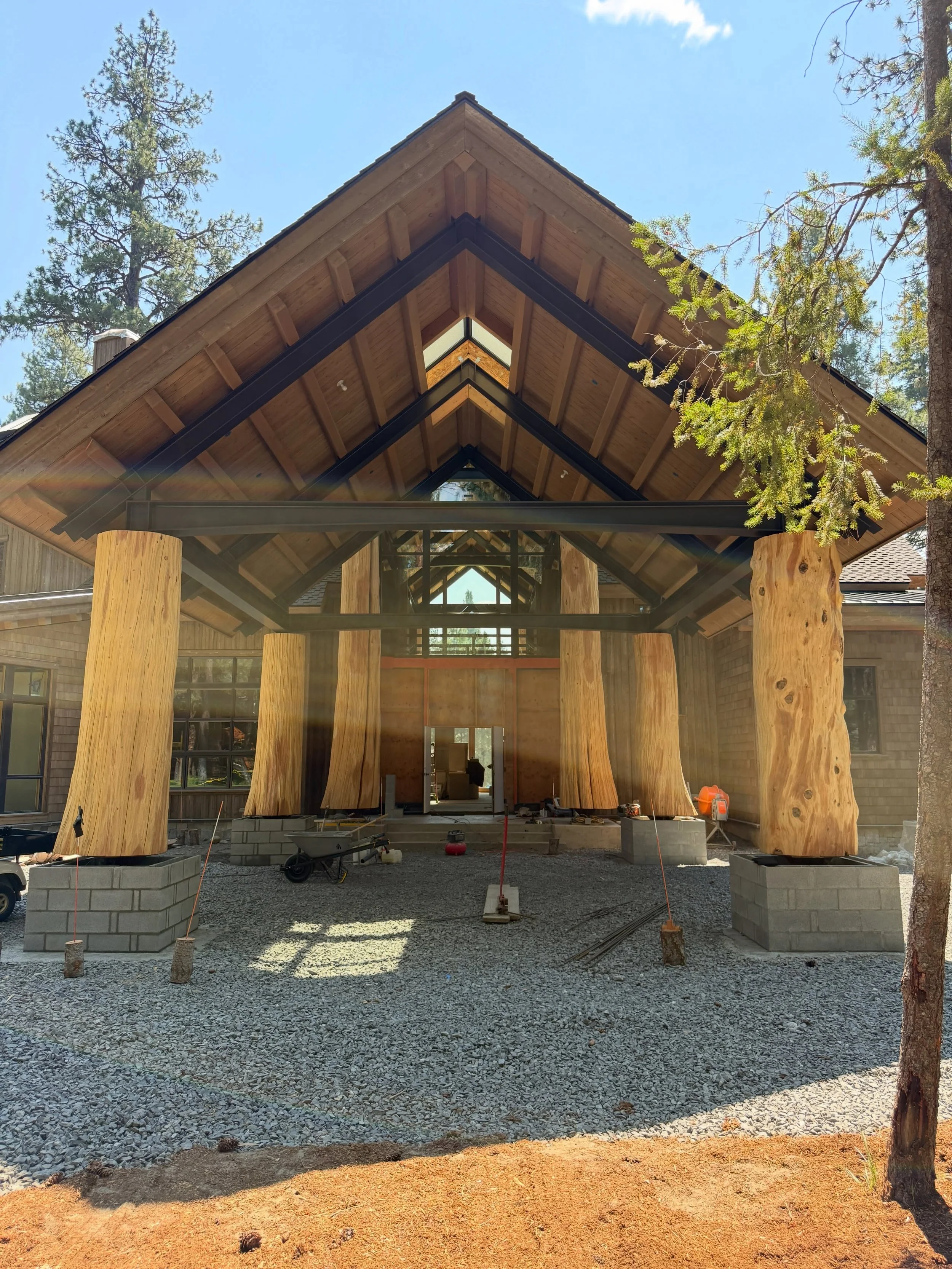 Block work under massive logs. I even got to have my nephew on site for a week, who learned some new masonry skills from the team #millerstoneworks #blockwork #masonry #homeentrance #stonemasonry