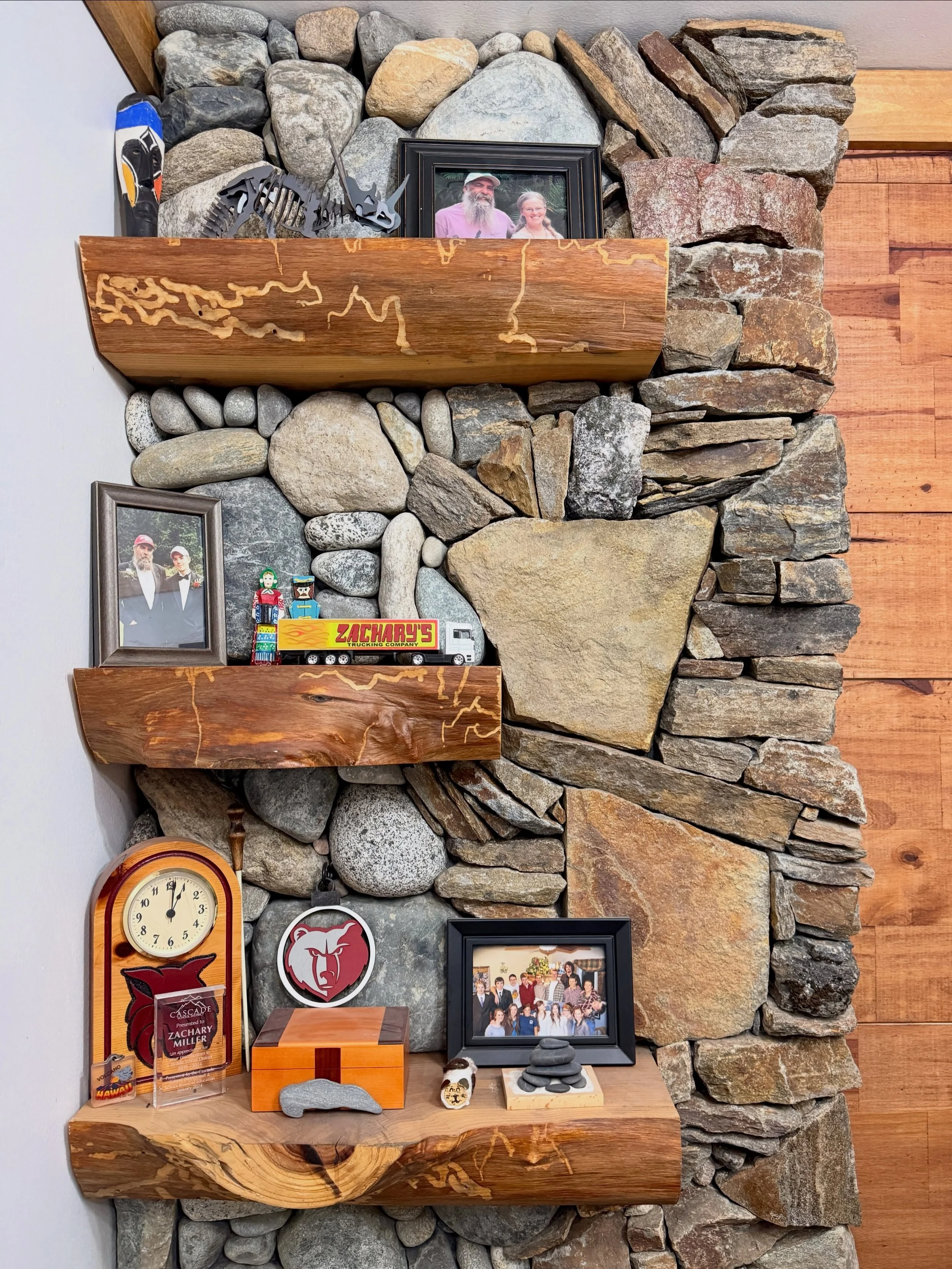 The best part of building something for yourself is experimenting. These were the steps of mixing river rock,  local schist, worm wood, and metal for a section of the wall in my home office. The shelves gave me a place to put all those little trinket