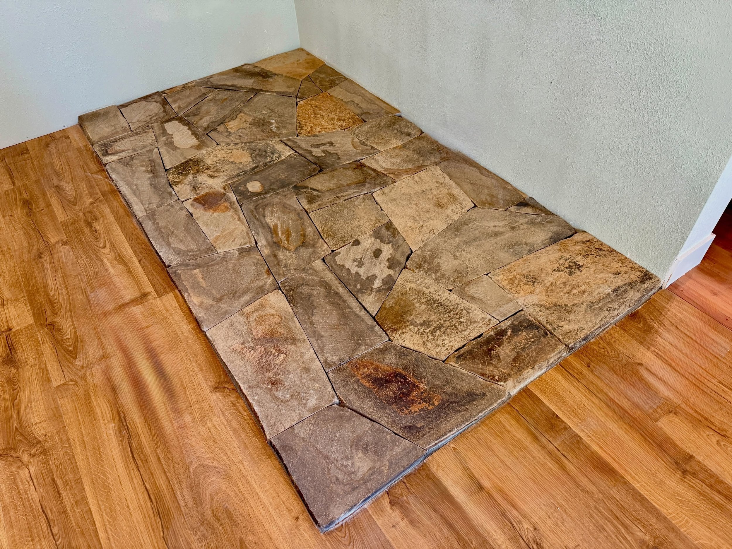Putting a floor piece together, one stone at a time #millerstoneworks #stonedesign #stonemasonry #woodstove #masonry