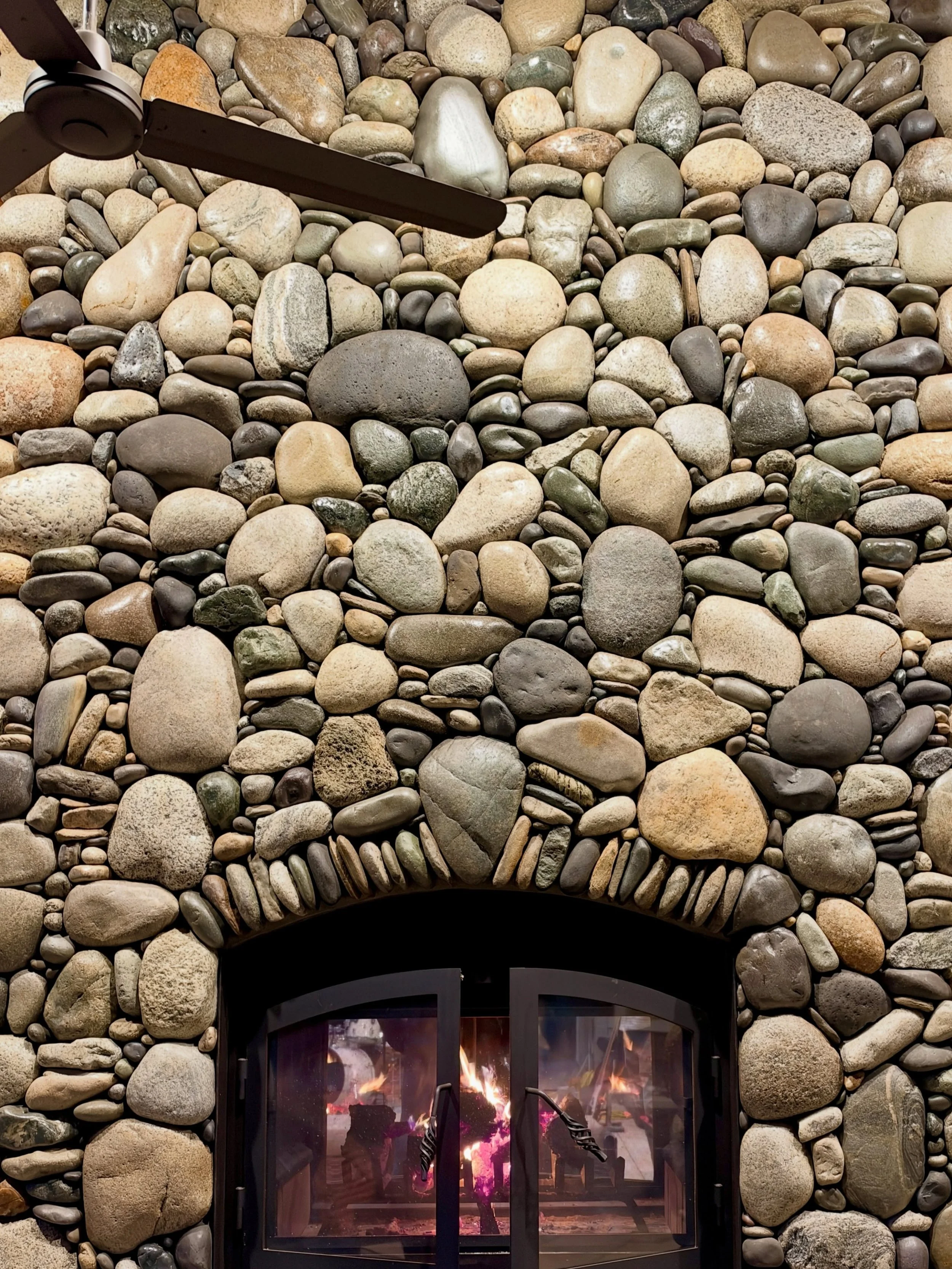 Stopped at a friend's house and got to see a fire lit in last year's big project. Everyone we work for becomes a friend #millerstoneworks #fireplace #stonefireplace #stonemasonry #riverrock
