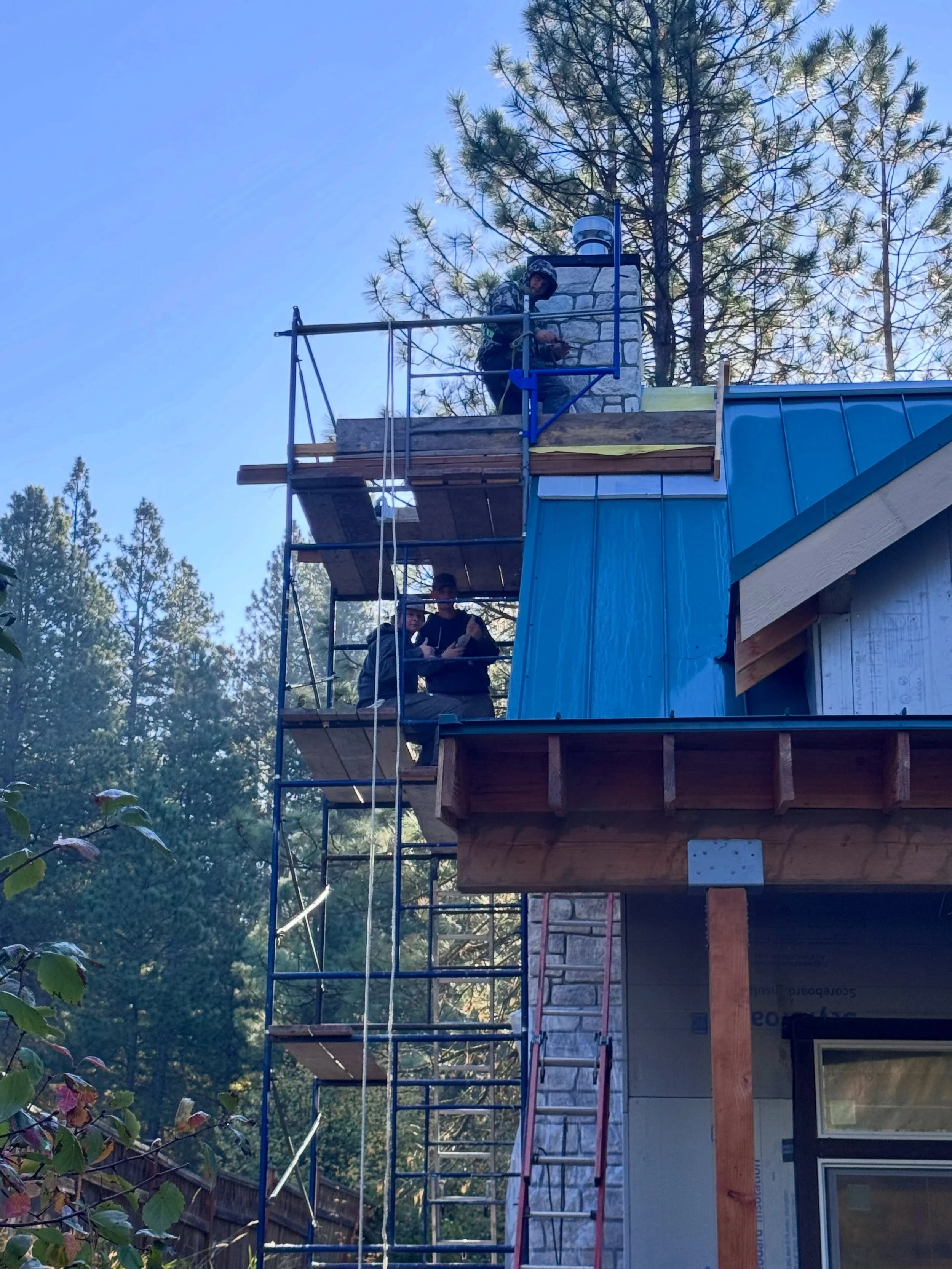 The team working their way to the very top of the chimney. Another day, another fireplace #millerstoneworks #fireplace #masonry #stonemasonry #scaffolding
