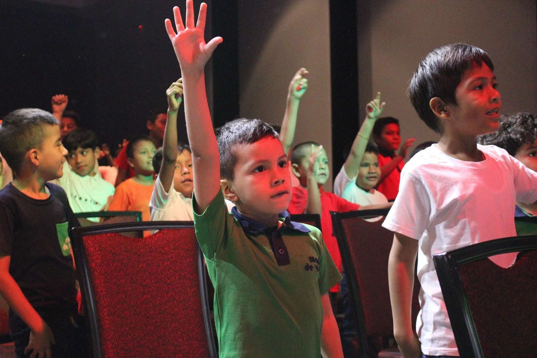 Children eagerly raising their hands