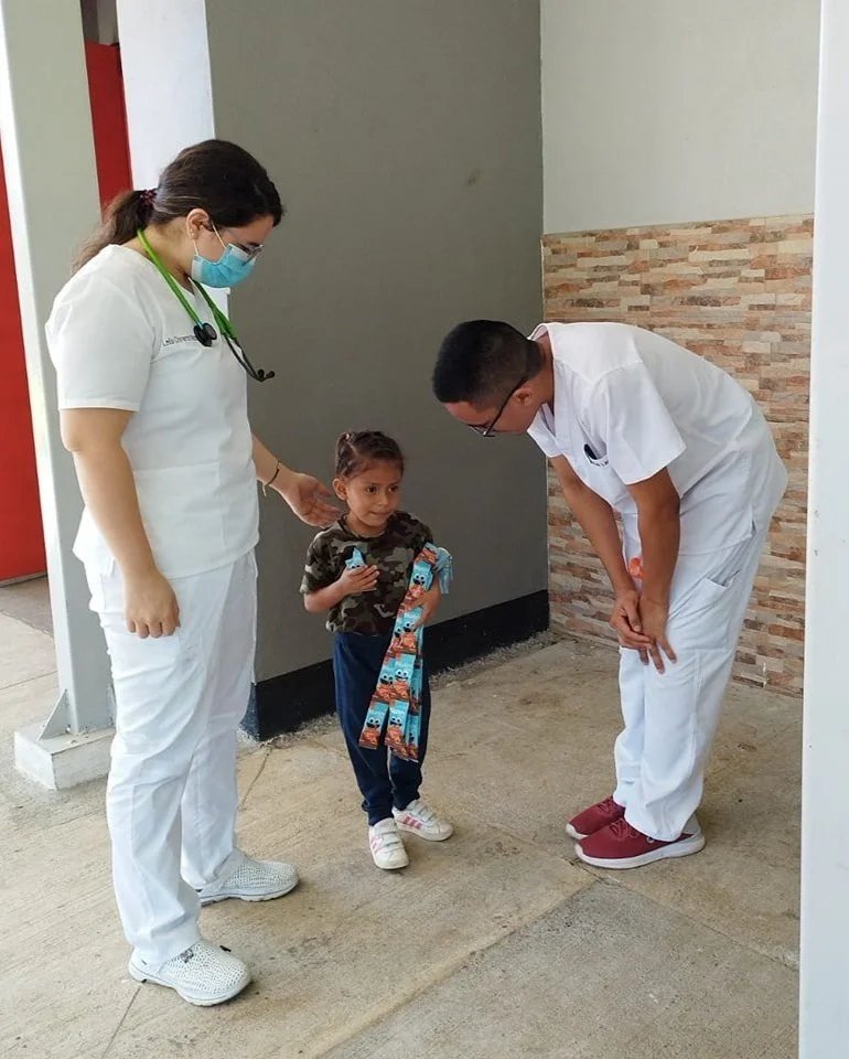 Doctors giving a child vitamins
