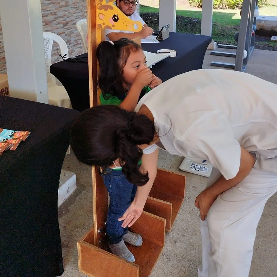 Medical professional measuring child