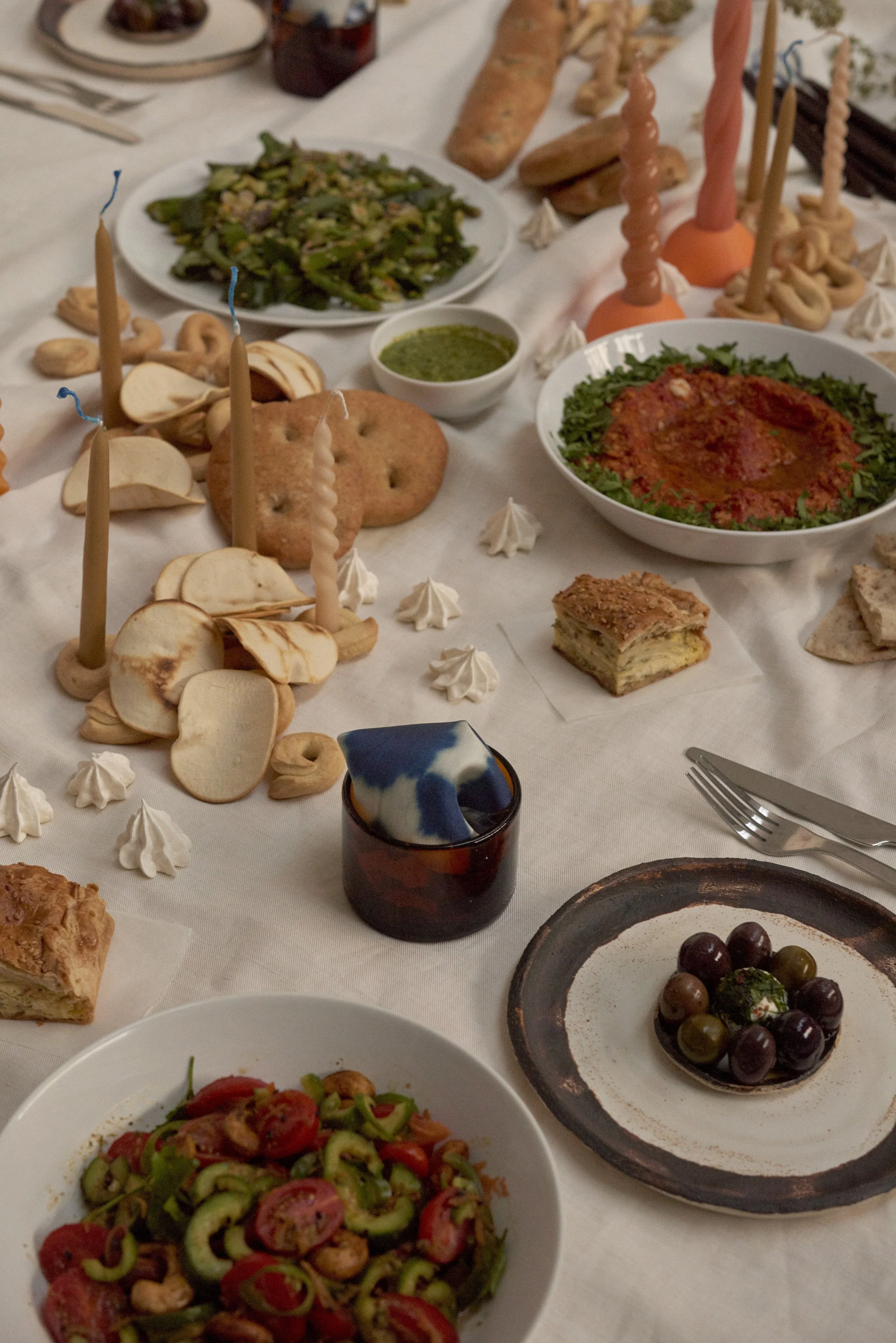 Table setting with food, olives, glasses, plates