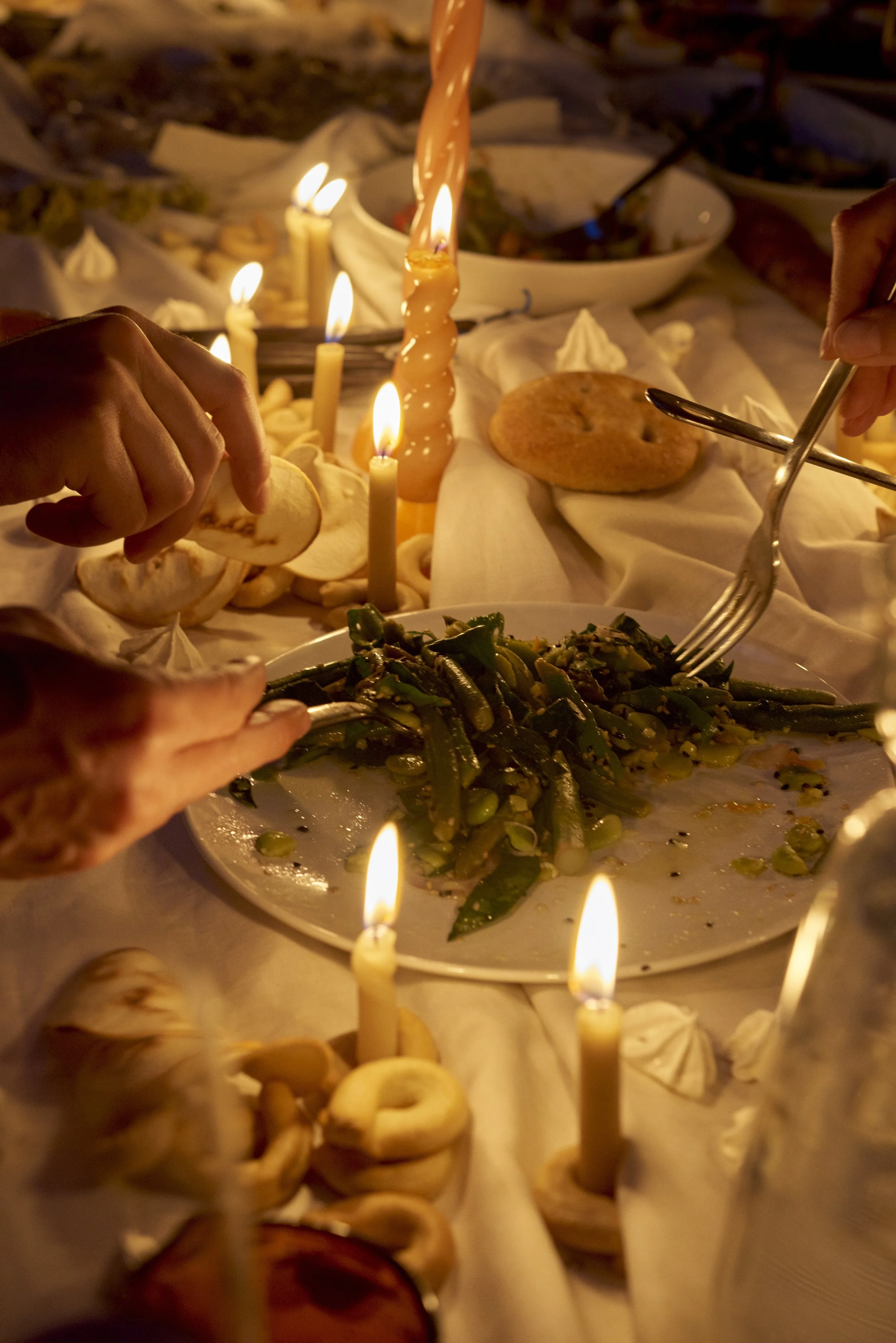 hands over plate of food candlelit