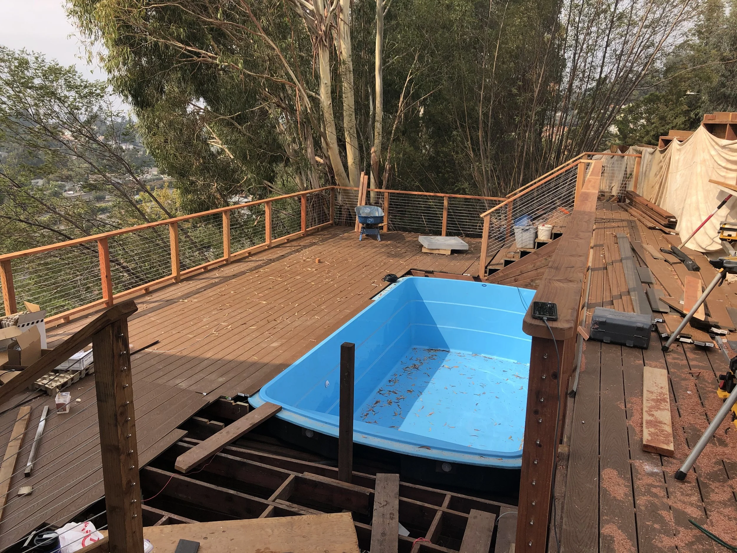 Deck renovation in Marin County showing new decking boards and stainless steel cable railing installation.
